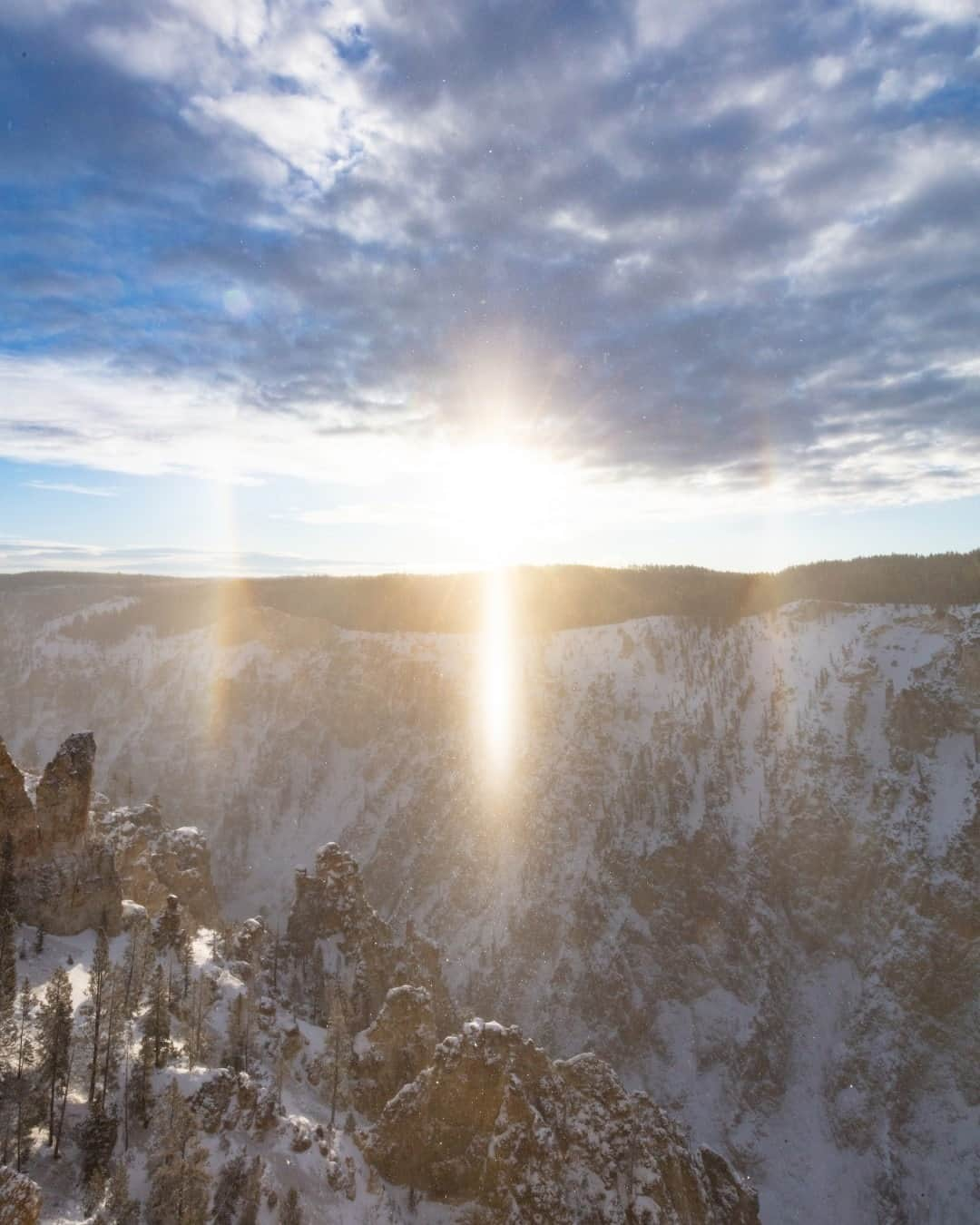 アメリカ内務省さんのインスタグラム写真 - (アメリカ内務省Instagram)「Snow is possible any time of year in Yellowstone National Park, but during the winter months, the park transforms into a wonderland of winter phenomena. One of which is the sun dog, or parhelion. They are a member of the family of halos caused by the refraction of sunlight by ice crystals in the atmosphere. Sundogs are most common when temperatures are extremely cold and the sun is low on the horizon.   If you plan to visit #Yellowstone in #Idaho, #Wyoming or #Montana this winter, plan ahead and prepare. Many of the features including Old Faithful and the Grand Canyon of the #Yellowstone (pictured here) are only accessible by guided #snowmobile or #snowcoach #tours. Photo @yellowstonenps by Jacob W. Frank, National Park Service. #usinterior #yellowstonenationalpark #yellowstoneNPS」11月19日 2時33分 - usinterior