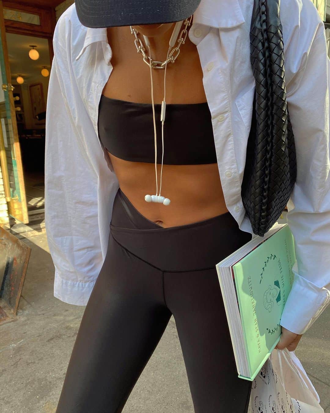 We Wore Whatのインスタグラム：「For my new active collection I shot street style photos in front of some of my favorite local small businesses. With each look I will be sharing a bit about them 🤍 this is the new shiny coated splice legging with bandeau sports bra.⁣ ⁣ First up is of course, @jackswifefreda. I’ve been coming here since the month they opened in 2012. Jack’s Wife Freda is an immigrant love story, they met and married in Johannesburg in 1930. Their grandson Dean, dreamed of moving to America where he met Maya who had too emigrated to NY from Israel. They are like family to me and this place will always feel like home. 🍽」