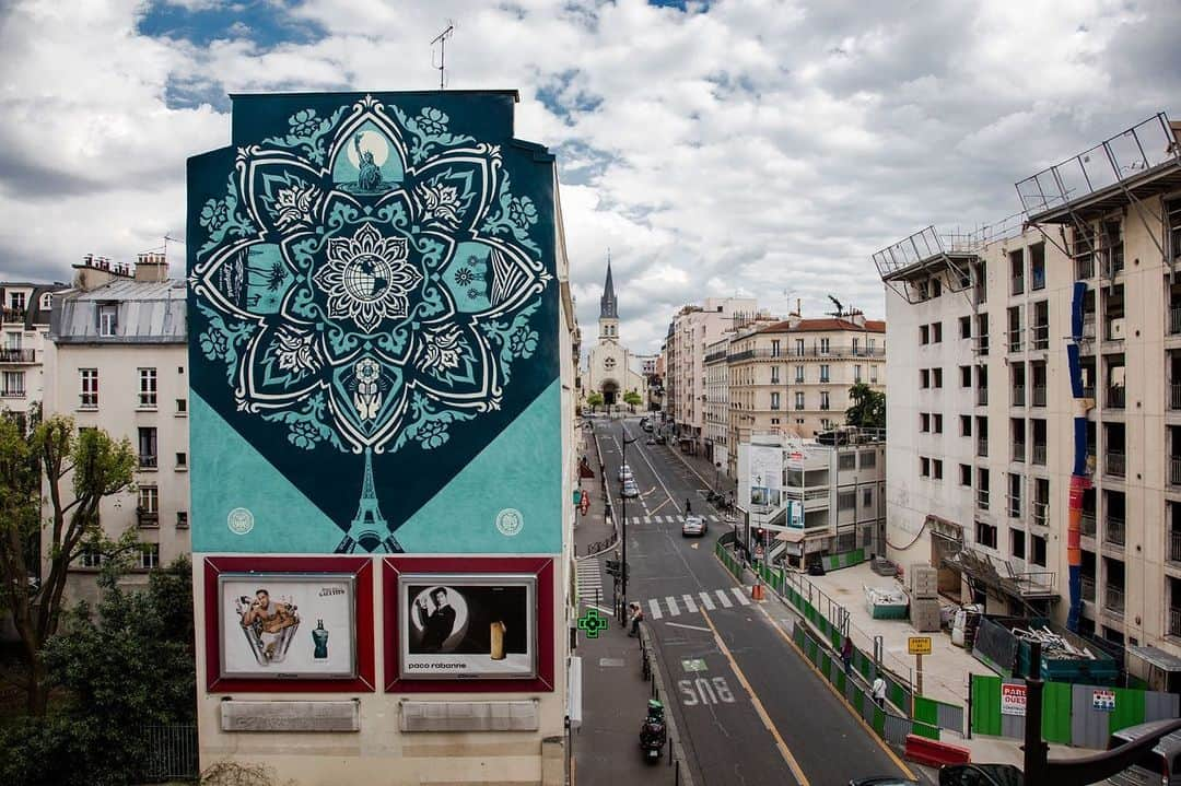 Shepard Faireyさんのインスタグラム写真 - (Shepard FaireyInstagram)「Traveling for gallery openings and murals is something I'm really missing this year. This week, I'm throwing it back to a very memorable trip to Paris in 2016. After my "Earth Crisis" installation at the Eiffel Tower during the COP 21 in 2015, Galerie Itinerrance and I planned a follow-up art show and murals to build on the concept and aesthetics of the "Earth Crisis" installation. I worked hard creating new pieces of environmentally-themed art and new versions of some older works in the aqua and blue colorway that I used for the Earth Crisis globe.⁠⠀ ⁠⠀ The weather forecast called for rain basically every day for the duration of the trip, but my team and I were able to catch some dry windows to jump on the murals. I realized that all the hours the crew and I have been putting into walls have made us faster, and we finished everything on time, even with the rain delays. I was incredibly moved by the Parisians' response who gathered daily, rain, or shine, to watch us work on the murals. When we finished the "Delicate Balance" mural, the assembled crowd cheered and clapped for a couple of minutes. I'm used to being chased, yelled at, questioned, and sometimes arrested for doing public art, so to be cheered was pretty emotional.⁠⠀ ⁠⠀ I remember feeling so grateful to so many Parisians for their enthusiastic support of my work. Many of the French I encountered apologized for not speaking English well, and I was a bit ashamed that I'm not multilingual. Regardless, I think the art spoke a universal language that communicated the idea that we are one people on one planet! Let's not forget that whatever language we speak or whatever country we reside in, we are in this all together.⁠⠀ -Shepard  Photos by @jonathanfurlong」11月20日 9時54分 - obeygiant