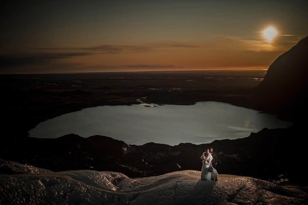 CANON USAさんのインスタグラム写真 - (CANON USAInstagram)「#CanonExplorerOfLight @susanstriplingphotography is taking over our page today! Stay tuned to see some of her incredible images. "This whole wedding was like a dream: go to Iceland and journey around with just the couple for an elopement with portraits anywhere I wanted? Oh, and on the second day, go climb a glacier with them? SIGN ME UP. This incredible woman hiked up a massive glacier with her wedding dress pinned up, and she is my hero! I wanted to showcase the couple in the extraordinary scenery but I had a few issues: I wanted to shoot wide open at f/1.2, use off camera light, AND capture the sky behind them.  My assistant (just off camera right) held a speed light to illuminate the couple, while high speed sync enabled me to shoot at 1/1000 to cut out the ambient light and darken the scene. I used an ND filter to be able to go all the way to f/1.2 and still retain the sky. This is one of my favorite images from this exceptional week."   📸 #Canon EOS R Lens: RF50mm F1.2 L USM」12月15日 23時02分 - canonusa
