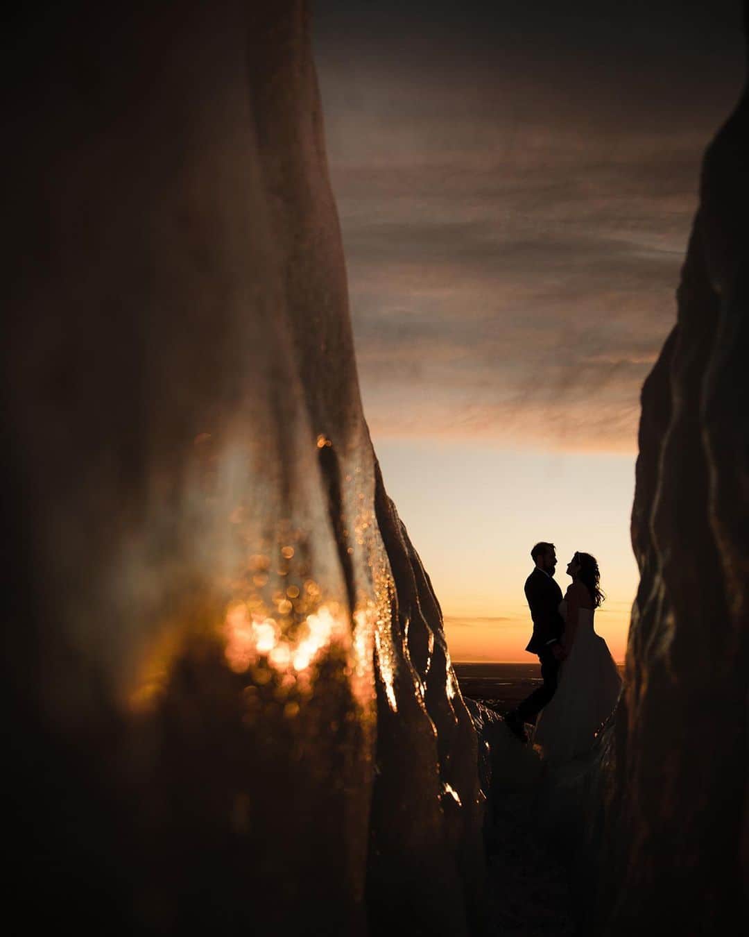 CANON USAさんのインスタグラム写真 - (CANON USAInstagram)「Photo by #CanonExplorerOfLight @susanstriplingphotography "Climbing a glacier with camera gear strapped to my back is something I NEVER thought that I’d do as a wedding photographer - but here I did! The sunset was extraordinary that day, and seeing the gold light reflecting off of the ice was truly outstanding. Every time I create an image I try to think of how I could see it differently than other photographers, and in this case I was stumped. How can I show the ice AND the couple AND the sky in a new way? The only clear answer was to wedge myself deep into a crevice in the glacier. I was backed up so far the ice was cutting into my arms and shoulders, and I could barely get the camera to waist height. I was so thankful that I could move the vari-angle touchscreen on my EOS R outwards so that I could compose my shot with the camera at a lower angle. I am also thankful for the guide who then helped me get out of the ice I was stuck in!"   📸  #Canon EOS R Lens: RF24-105mm F4 L IS USM」12月16日 6時33分 - canonusa