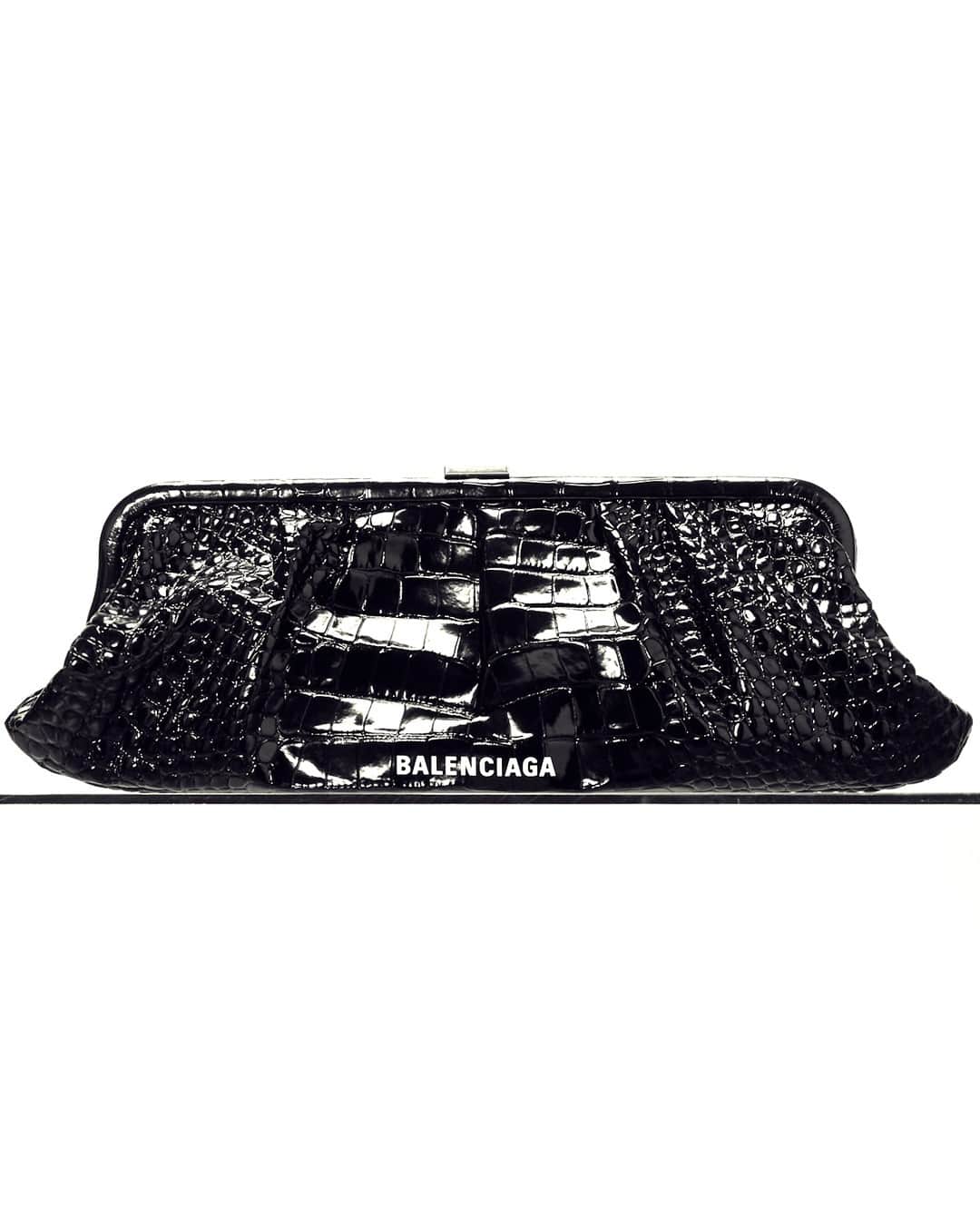 エルエヌシーシーのインスタグラム：「Balenciaga is renowned for delivering sculptural volumes, modern opulence and reimagined classics. The Cloud XL Leather Clutch features a croc-embossed finish, detachable shoulder strap and logo print detail.  Shop new season @balenciaga  ready-to-wear and accessories online now.」
