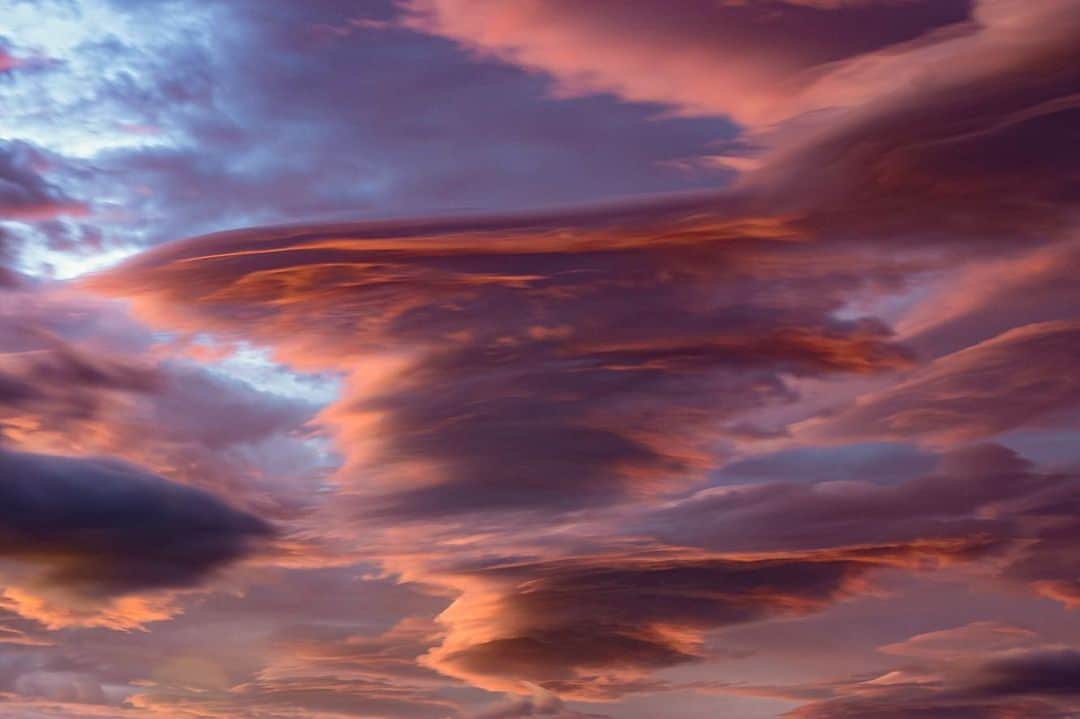 National Geographic Travelさんのインスタグラム写真 - (National Geographic TravelInstagram)「Photos by @babaktafreshi / I was on Ring Road in a northern town in the less visited part of Iceland. Moments after sunset the overcast sky began to open. An impressive display of lenticular clouds were still reaching sunlight at their high altitude. Swipe for a closer view of the multilayer clouds resembling a stack of pancakes! Lenticulars reflect light much more than usual clouds, making them appear bright.  Explore more Earth and sky photography with me @babaktafreshi. #sunset #nature #iceland」12月19日 0時40分 - natgeotravel
