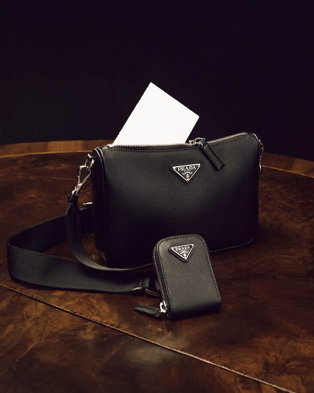 プラダさんのインスタグラム写真 - (プラダInstagram)「A Saffiano leather shoulder bag holds a secret note - and an extra zippered pouch on a detachable nylon shoulder strap. It and other #PradaGifts are featured in “A Stranger Calls”, the #PradaHoliday20 campaign.  Discover more via link in bio.  #Prada」11月27日 5時00分 - prada