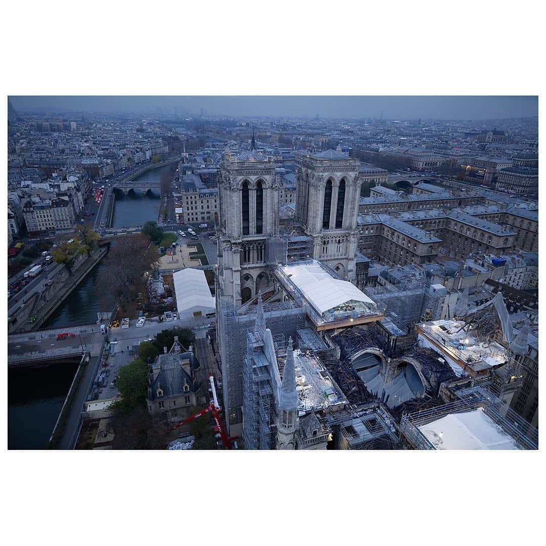 National Geographic Creativeさんのインスタグラム写真 - (National Geographic CreativeInstagram)「Images by Tomas van Houtryve @tomasvh / After an early morning of shooting, photographer Tomas van Houtryve climbs down from the 80 meter crane overlooking the Notre-Dame cathedral of Paris. This week, workers finished removing 200 tons of melted scaffolding that was damaged during the April 2019 fire. The scaffolding had been installed for restoration efforts previous to the fire. Until it was removed, it posed a risk to the damaged structure of the cathedral below.  . . .  Follow @tomasvh and the public institution in charge of reconstruction, @rebatirnotredamedeparis for more on Notre-Dame.   . . . #notredame #notredamedeparis」11月27日 22時26分 - natgeointhefield