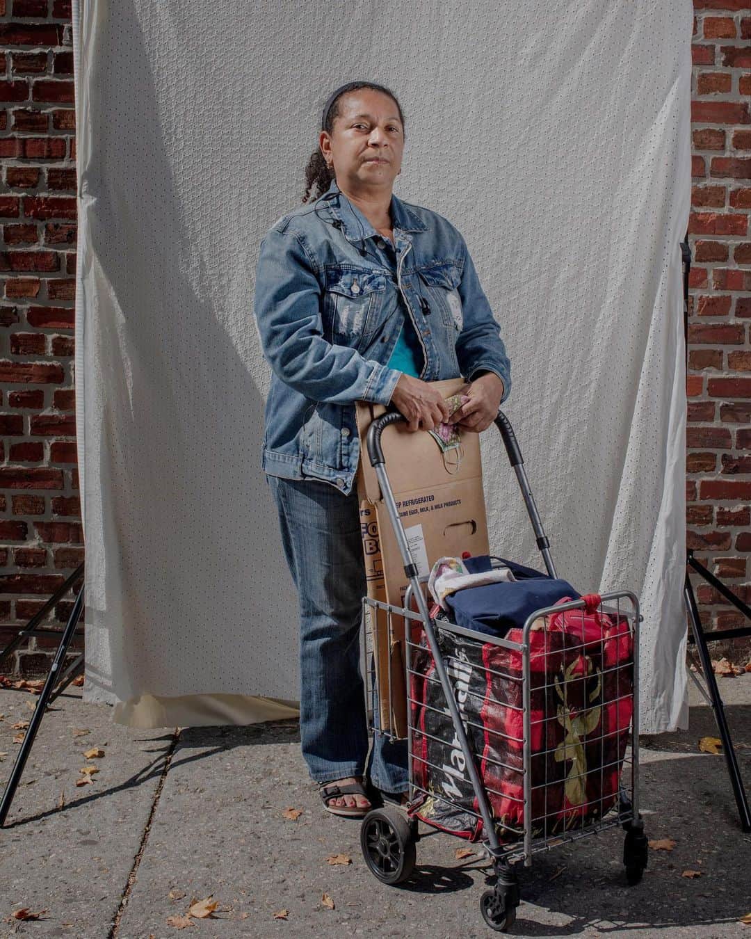 National Geographic Creativeさんのインスタグラム写真 - (National Geographic CreativeInstagram)「Photo by @nataliekeyssar / Luz Rodriguez poses for a portrait in a street studio I set up outside a food distribution event at  CENTI, a local church in Queens that passes out around 500 boxes of groceries to those in need every week. Rather than  focusing on the winding lines of those waiting for food in the wake of the pandemic, I wanted to create a space to connect with the people I was photographing, and hear more about their situations. Those who wanted to could come over for a portrait and an interview during the hours they spent waiting for food.  Luz is currently out of work and so is her whole family. She lives with her mother, her children and her brother. She says she’s very grateful for all the help she’s received in the midst of such a difficult situation. She worked for an 87-year-old man, taking care of him for the last 15 years. He got COVID-19 and died two weeks later, and since then she’s been without work.  Queens was was hit very hard by the first wave of the pandemic in NYC in the spring. The community is largely essential workers, from delivery drivers to cooks, cleaners, and construction workers, many of whom did not have the option to work from home. With population density and many living in tight quarters, infection rates in the area were very high. Tragic losses of life were compounded by the economic fallout, as many lost their jobs or had their incomes cut, and a continued high cost of living in the city. Now Queens is wrestling with rampant food insecurity. Families struggling to make ends meet are finding innovative ways to participate in the informal economy and depending on food donations to get by, and churches, government programs, and community organizations are mobilizing to help in every way they can.  Follow me @nataliekeyssar for more stories about resilience in hard times.  @FeedingAmerica is the nation’s largest hunger-relief organization with a network of 200 food banks and 60,000 food pantries and meal programs that together provide food to more than 40 million people per year. Learn more at feedingamerica.org/FeedTheLove. #FeedTheLove」11月28日 0時08分 - natgeointhefield