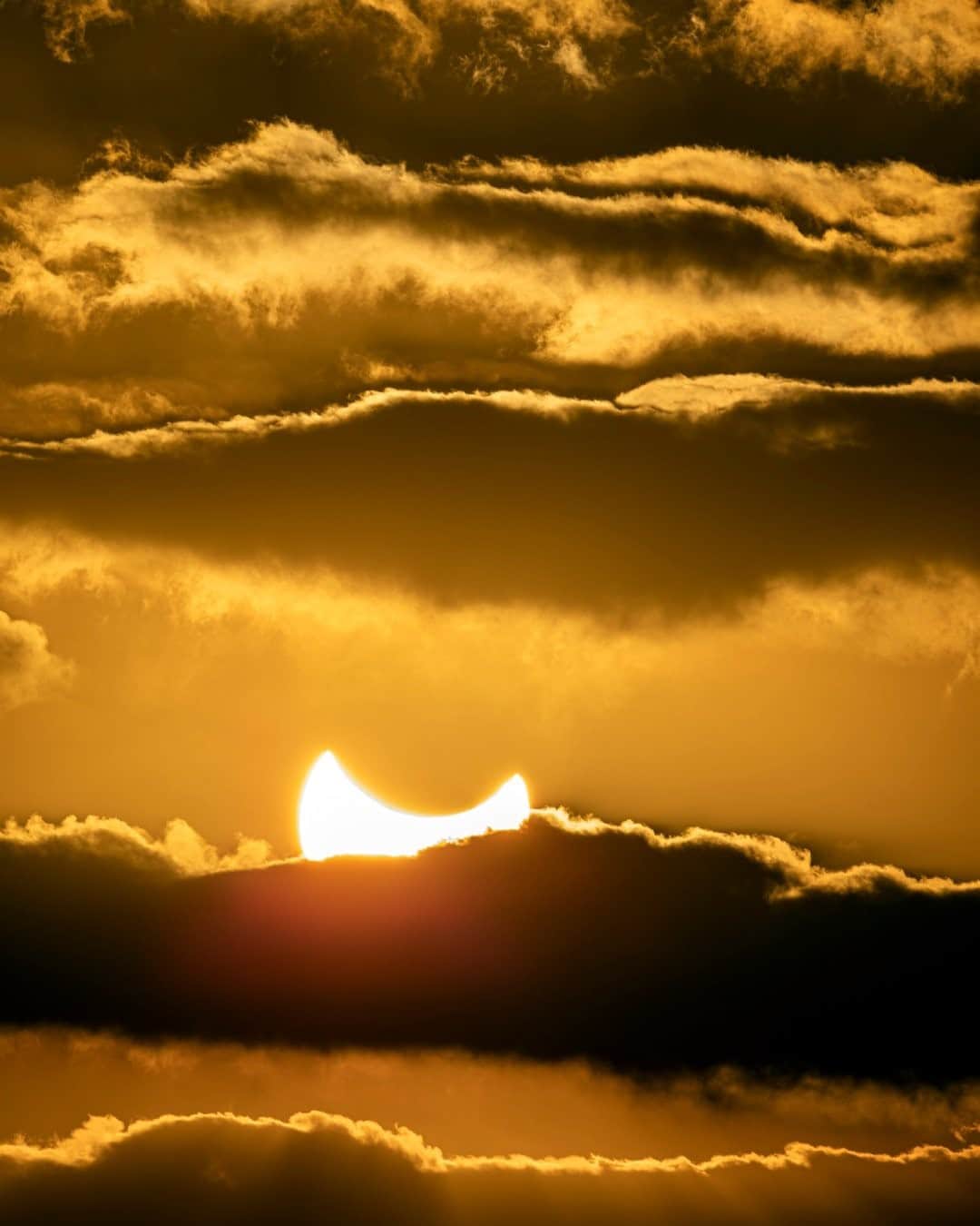 National Geographic Travelさんのインスタグラム写真 - (National Geographic TravelInstagram)「Photo by @babaktafreshi / On this morning in December 2019 the rising sun in Oman was eclipsed by the moon. I had a solar filter on the lens to safely photograph this. This year, on December 14, a spectacular total solar eclipse will happen in southern Chile and Argentina. The totality will last about two minutes. The much longer partial eclipse phase will be visible from Bolivia, Brazil, Ecuador, Paraguay, Peru, and Uruguay. There are usually many tours and research expeditions for every total eclipse that bring many tourists to the narrow band of moon shadow on Earth, but few people are expected to travel internationally for this eclipse as the pandemic continues.  Explore more Earth and sky photography with me @babaktafreshi. #solareclipse #eclipse」11月28日 8時35分 - natgeotravel