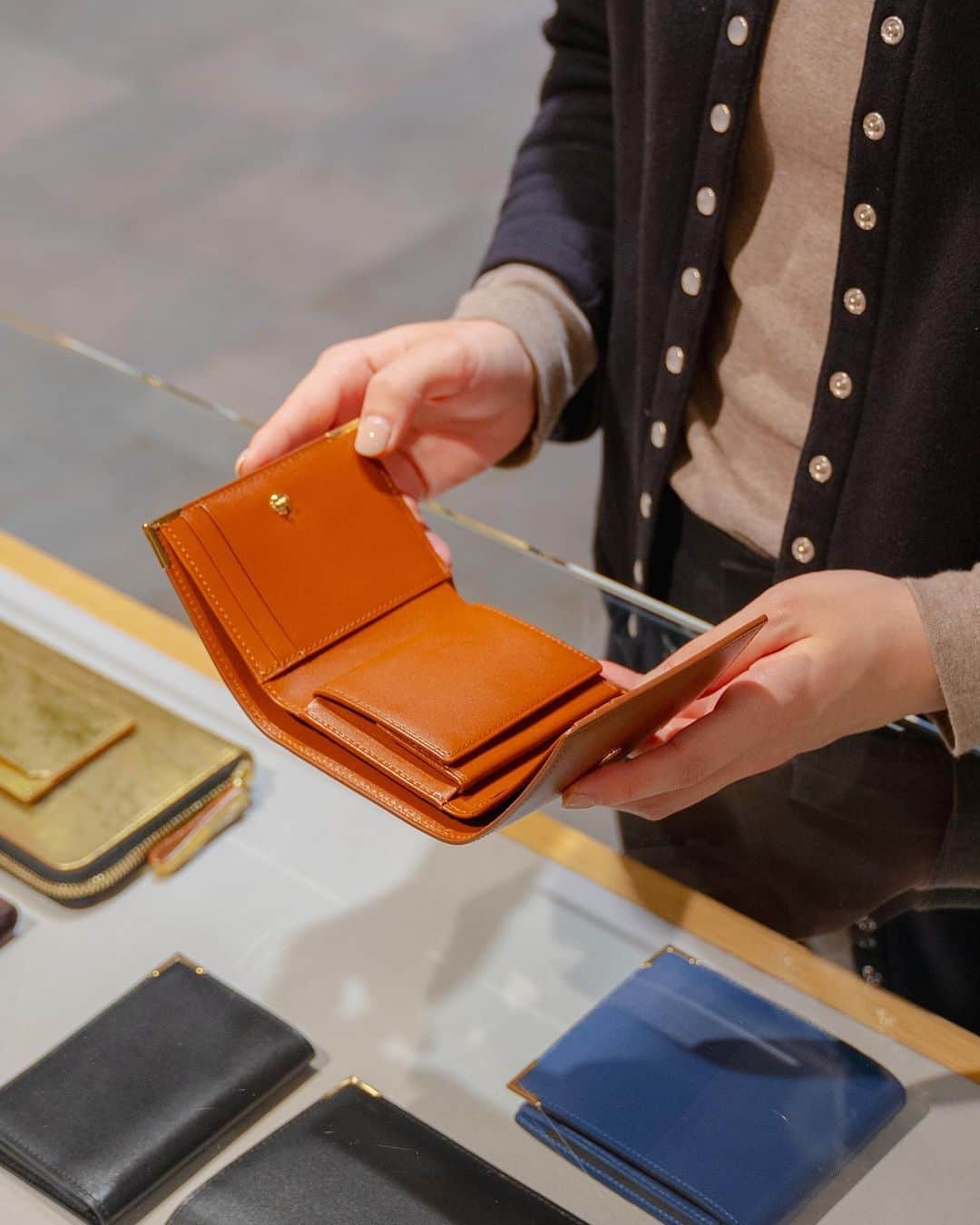 のインスタグラム：「. これからのギフトシーズンにおすすめの上品で高級感のある「PORTER CHARMANT（シャルマン）」シリーズです。  キメが細かく柔らかいフランスの最高級カーフを使用し、型からオリジナルで製作したゴールドのコーナー金具を施すことで、エレガントでオーセンティックに仕上げました。  表革はフランスの名門タンナー、デュプイ社の「シャトーブリアン」を使用しています。通常のボックスカーフに比べ、柔らかいタッチ感や独特のコシ、美しい肌目が魅力です。染料と顔料を少量ずつ加えた独自のセミアニリン仕上げで、透明感のある綺麗な色艶をお楽しみいただけます。  ゴールドのコーナー金具は、1930年代にイギリスで作られたトラベルウォレットなどに見られた装飾がモチーフです。当時はスターリングシルバーを使用し、ピンなどで丁寧に留めており、そのディテールをゴールドで取り入れてアクセントにしました。 背面には、PORTERロゴをレーザー加工で施したICカードポケットを取り付けました。 さらに、PORTERロゴをゴールドの箔押しで施したオリジナルの桐箱が付属します。  PORTER CHARMANT COMPACT WALLET ￥43,000＋tax W103/H84/D34mm  ぜひこの機会に店頭でお手にとってご覧ください。  #yoshidakaban #porter #luggagelabel #porteryoshida #madeinjapan #japan #porterstand #charmant #longwallet #wallet #cardcase #france #dupuy #boxcalf #leather #paulowniabox #吉田カバン #ポーター #日本製 #ポータースタンド #シャルマン #ウォレット #財布 #カードケース #革 #レザー #桐箱」