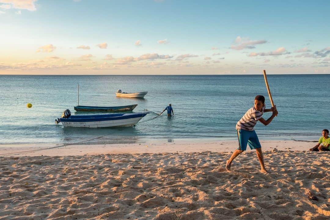 National Geographic Travelさんのインスタグラム写真 - (National Geographic TravelInstagram)「Photos by @francescolastrucci / Boys play baseball at sunset on the beach of Punta Rucia, between the towns of Puerto Plata and Monte Cristi, on the Dominican Republic’s northeast coast. Punta Rucia is a delightful, uncrowded white sand beach lapped by calm, crystal clear waters protected by the coral reef. I particularly enjoyed the time when locals would come to the beach to play, chat, and relax at the end of a long day.  Follow me @francescolastrucci for more places, daily life, and stories around the world. #republicadominicana #dailylife #sea #beachlife」12月2日 4時40分 - natgeotravel