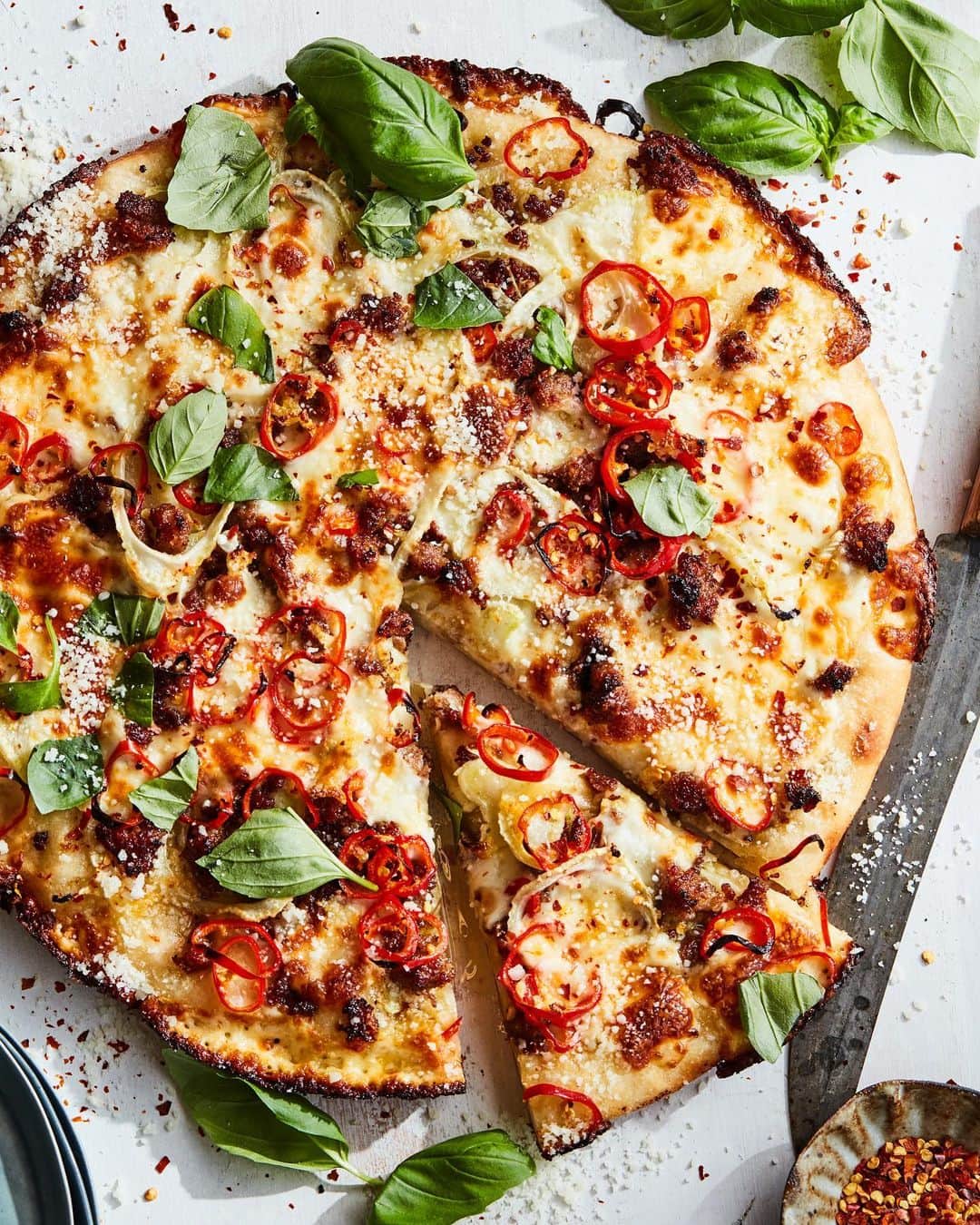 Gaby Dalkinのインスタグラム：「Remember that epic Detroit Style Pizza we did a few weeks ago - LET’S DO IT AGAIN! But this time with a Sweet Fennel and Sausage topping. #ad OMG YES! Grab a @jimmydean Premium Pork Sausage , some fennel and cheese and you’re in business. Everything about this recipe is next level amazing from the cheesy topping, the savory sausage and the epic crust. Plus - it saves really well so you can keep the leftovers for 3-5 days if you don’t take it down on the first night!! Perfect for a family game night this holiday season! Get into it! Link in my profile for more recipes. http://www.jimmydean.com/recipes #JimmyDeanHoliday  8 oz. Jimmy Dean Premium Pork Regular Sausage  3 tbsp olive oil 1 batch Detroit style pizza dough, recipe below ½ small fennel bulb, very thinly sliced 8 ounces brick style whole-milk mozzarella cheese, cut into 1/2-inch cubes 1/2 cup olive oil, mixed with 8 cloves of chopped garlic red fresno chiles to garnish (optional)  red pepper flakes, basil and oregano to garnish  For the Dough 2 1/4 cups all purpose flour 2 teaspoons kosher salt 1 teaspoon rapid rise yeast 1 teaspoon white sugar olive oil as needed   Dough directions are on the blog!   Position an oven rack in the bottom of the oven and preheat to 500 F. Heat 1 Tbsp. oil in a large cast-iron skillet over medium. Cook sausage, breaking up into small pieces with a wooden spoon, until browned in spots and cooked though, 5–8 minutes. Transfer sausage to a small bowl and drain any excess fat.   Pour the remaining olive oil in a large skillet. Put the dough in the pan and gently stretch it out to fit so the dough reaches the corners.  Drizzle half of the garlic oil sauce on top. Layer the sausage and sliced fennel on the dough. Then lay the cheese cubes all over, especially around the perimeter up to the edge of the pan. Drizzle the rest of the garlic oil sauce on top and scatter with sliced red fresnos.  Bake until bubbly and golden and a crispy cheese crust has formed, 10 to 15 minutes. Use spatula to loosen up the edges and remove the pizza from the metal pan and place on a cutting board. Slice and serve with garnishes.」