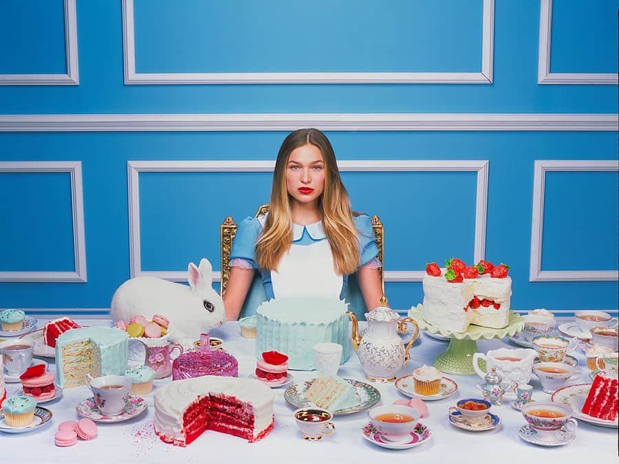 タイラー・シールズのインスタグラム：「Alice in Wonderland. When I said Alice in Wonderland was a dream shoot of mine, I got a message from @ali_collier who I have worked with many times, and she said “if you ever do it I am in” I said to her let’s make it happen, I had the dress custom made rented a bunny and bought enough Cake to feed an Army, then the photo was done, every detail from the tea cups to the bunnies eyes to Ali’s face draw you in, this is surely going to be a powerful print, and a fun conversation starter when on a wall. Swipe right to see the behind the scenes, and yes the bunny is real! My question is where would you hang this print?」
