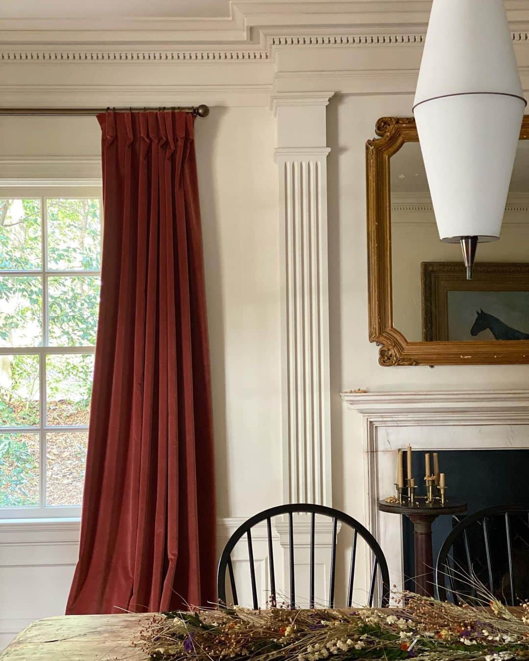 ブルックリン・デッカーのインスタグラム：「Home post! We still haven’t finished our house, despite moving in a year ago, but these details bring me joy:  1. The original plaster molding we fell in love with immediately, the original owners used this space as two formal living rooms, we combined it into one long dining room.  2. A cozy chair in front of my great-grandma’s hope chest that my dad restored himself.  3. An antique I found online (on the ground next to it is the light fixture that will eventually be hung in this room)  4. My favorite weirdo lamp on top of my favorite nightstand (I won the nightstand in an online auction.)   I used to really avoid color. I wanted all wood, white and black. I grew up in a house FULL of color and I couldn’t get away fast enough... funny, as I’ve gotten older I find myself attracted to my mom’s favorite colors. Reds, greens, yellows. Turns out the apple doesn’t fall far from the tree.」