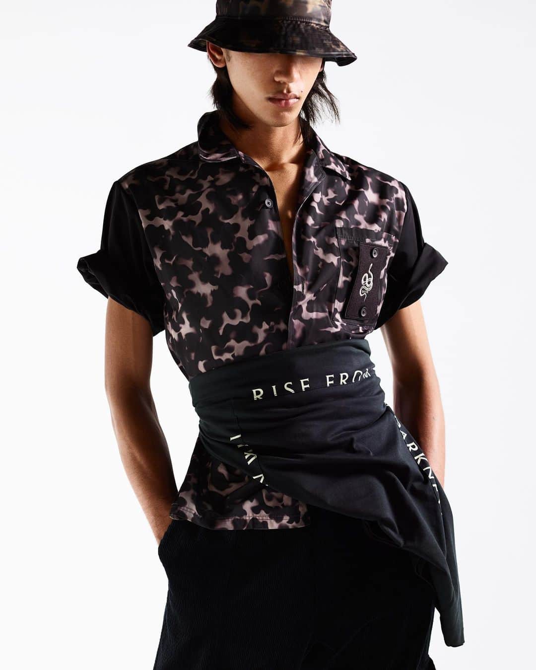 カシミ オムのインスタグラム：「Accentuate the waist by wrapping Huqayq - a long sleeved, printed T-shirt with the message: “A Moon Will Rise from My Darkness” - over our Shirazi tortoise shell printed bowling shirt in technical fabric.  #aw20qasimi #qasimi #mensfashion #menswear」