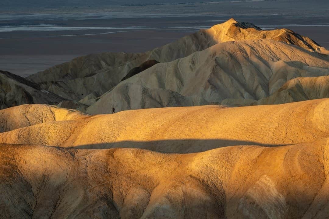 National Geographic Travelさんのインスタグラム写真 - (National Geographic TravelInstagram)「Photo by @KristaRossow / A lone photographer walks along a ridge at first light, dwarfed by a rolling landscape in Death Valley National Park. Death Valley is the hottest, driest, and lowest of the national parks. For more images, follow @KristaRossow. #DeathValley #sunrise #landscape #California」12月6日 0時37分 - natgeotravel