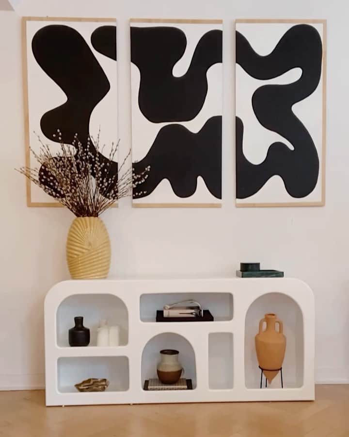 We Wore Whatのインスタグラム：「Temporary wall update (before I move in the Spring). Fun fact, I’ve moved seven times in seven years before my current apartment and have been through so many interior design phases. Over the past two years I started invested in vintage designer furniture that will stay with me till my forever home. Channeled my inner @eyeswoon here (Athena has the most exquisite taste and is always inspiring me). ⁣ ⁣ Console: @urbanoutfitters  Art: @hannahpolskinstudio  Objects: @claudehome, @etsy, @1stdibs, @assouline, and other vintage books/pieces」