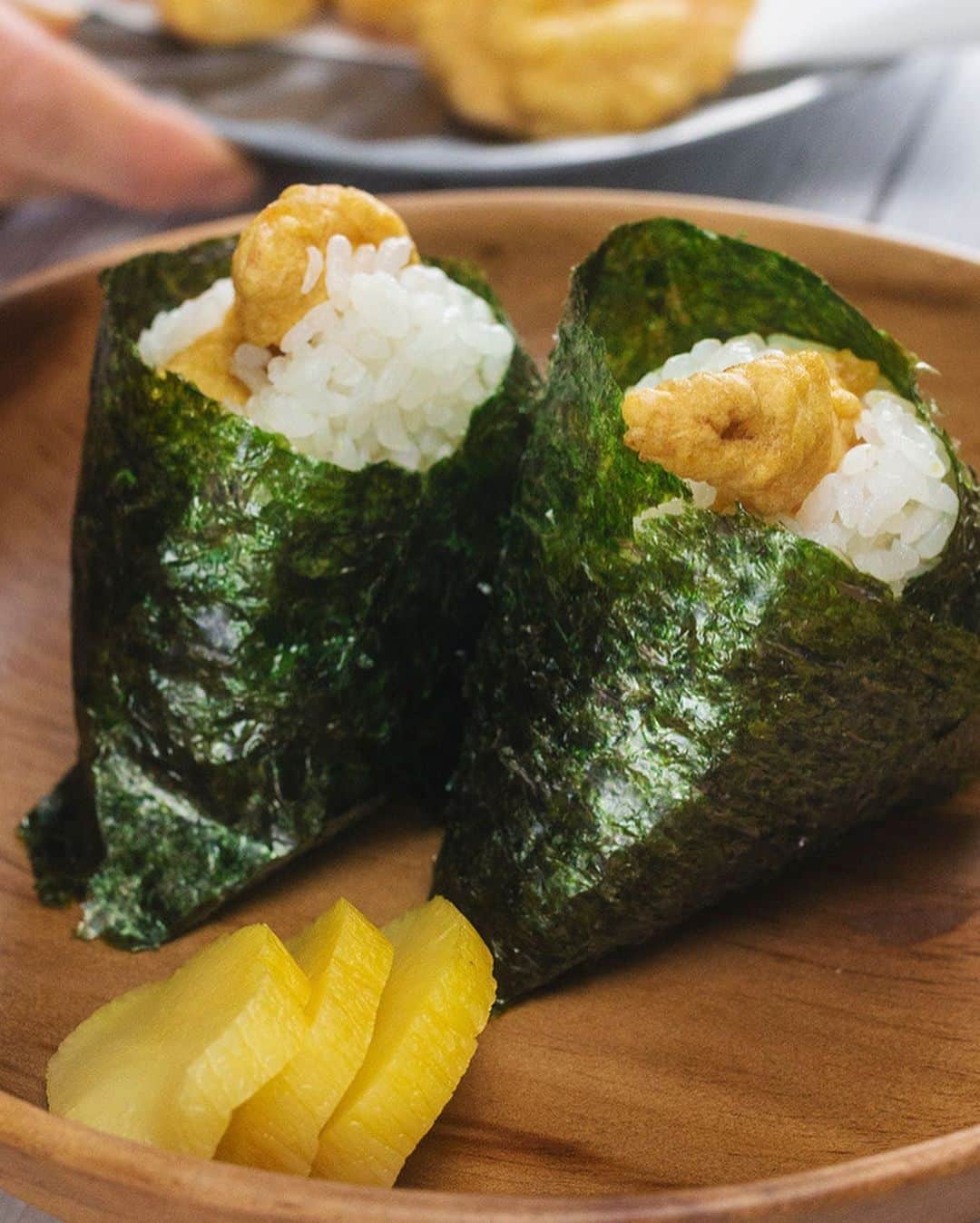 MUJI USAさんのインスタグラム写真 - (MUJI USAInstagram)「The perfect addition to any bento box or on its own as a simple snack.  Tenmusu consists of warm rice and shrimp tempura encased in nori (seaweed). Here's a MUJI recipe from Chef Naoko on how to create your own shrimp rice balls.  Ingredients [Washing Shrimp] 1 tbsp potato starch 1 tbsp salt 2 tbsp water  [Tempura Batter] 50g all-purpose flour 1 tsp salt 1 egg Iced water *Egg and water should total 100cc. Do not premix.  8 small frozen or fresh shrimp 3 tbsp potato starch 3 sheets of nori (seaweed) 2 cups vegetable oil Rice  1. Peel shrimp and rub with the potato starch, water, and salt. Rinse in water after shrimp is thoroughly cleaned. 2. Drain and dry with paper towels. Coat the shrimp with the potato starch. 3. To make tempura batter, mix the egg and salt. Slowly add the flour and water. Gradually mix everything together, taking care not to overmix. 4. Heat oil in a frying pan to 365 degrees. Use chopsticks to dip shrimp into the tempura batter, and place in the pan once well-coated. Fry for 1-2 minutes. Repeat with all shrimp. 5. Remove from frying pan and drain on a wire rack. 6. Wash the rice, drain, and set aside for 15 minutes. Then, place in a rice cooker with equal parts water and cook. 7. When rice is cooked, place 50g onto your wet palms with a pinch of salt. Place a piece of tempura in the center and shape into a rice ball. Careful, as the rice will be hot. 8. Cut the seaweed into 4 equal parts  and wrap around. 9. Serve and enjoy!  @shizukupdx @chefnaoko  #muji #mujiusa #mujirecipe #chefnaoko #tenmusu」12月11日 8時01分 - mujiusa