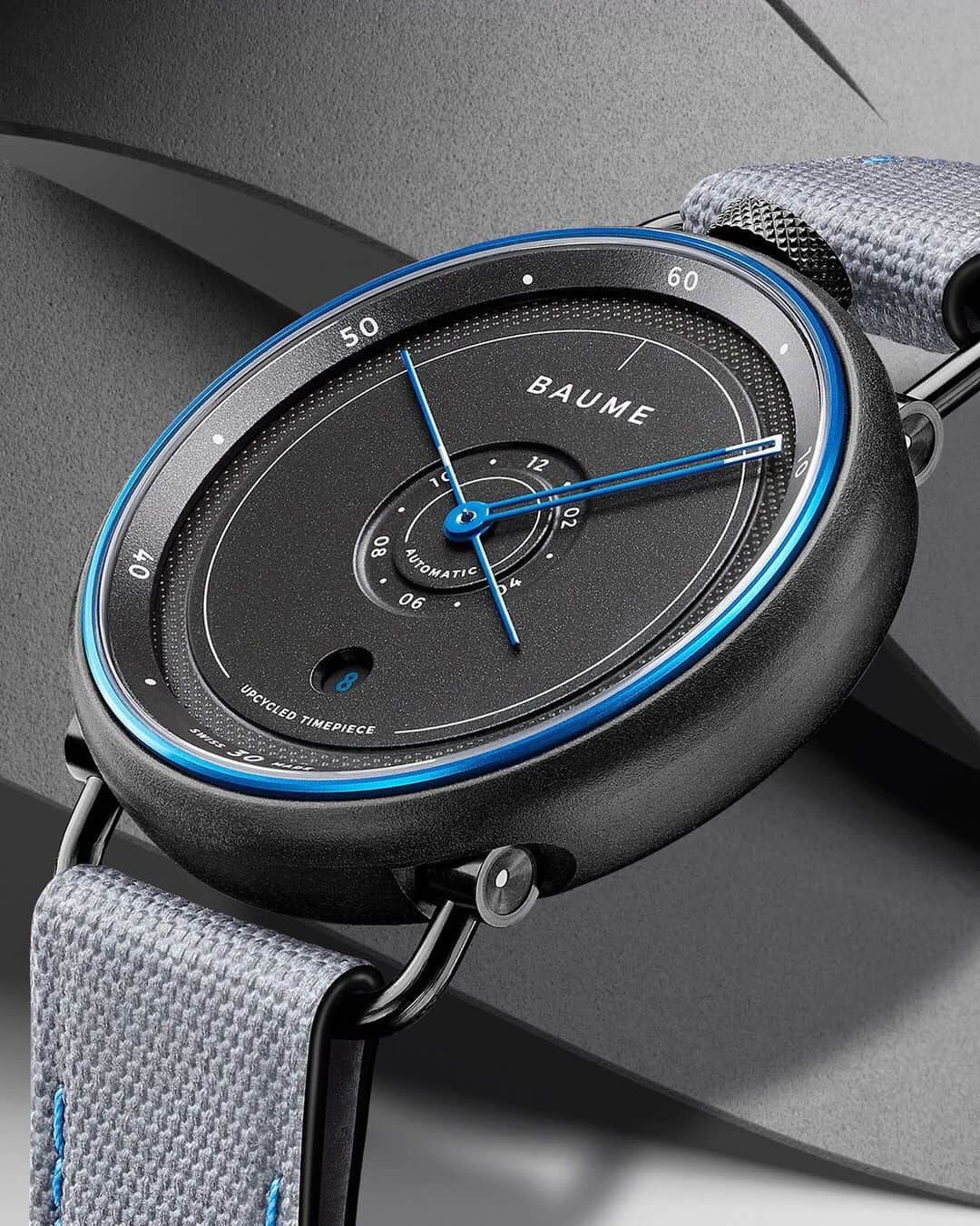 ボーンメルシーのインスタグラム：「The Baume Ocean. Swiss-Made x Sustainable timepiece. -- BAUME Ocean Limited Edition 10587 Automatic – Date, 42 mm marble grey recycled polypropylene and blue anodized aluminium case, interchangeable grey woven recycled PET strap with blue stitching, 38-hour Power reserve. -- #baumeetmercier #baumeocean #swissmade #sustainable #design #naturalmaterials #recycled #wastefreeoceans #seaqualinitiative」