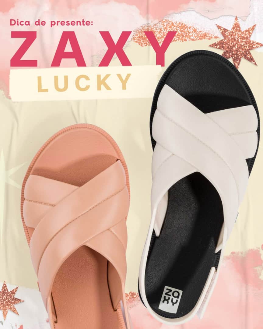 のインスタグラム：「Você é daquelas que não abre mão da praticidade? A #ZaxyLucky é perfeita pra você! Com o efeito de gominhos nas tiras em X e um fechamento super fácil, a gente tem certeza que você vai curtir esse modelinho! #FimDeAnoZaxy  #ZaxyLucky - R$49,99  Compre agora mesmo pelas tags no post, pelo link na bio ou na nossa loja online www.zaxy.com.br  #pracegover #pratodosverem: Na foto, temos o fundo rosinha claro com alguns rasgos e estrelas com glitter. À frente, temos 2 modelos da Zaxy Lucky. Esse modelo possui tiras em X com efeito de gominhos e o fechamento traseiro.」