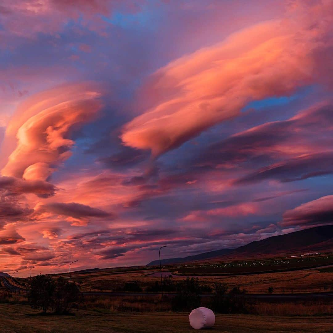 National Geographic Travelさんのインスタグラム写真 - (National Geographic TravelInstagram)「Photo by @babaktafreshi / Slowly swipe to see this panoramic view during an impressive display of lenticular clouds in northern Iceland right after sunset, when rays of light were still reaching these high stationary clouds. Some lenticulars are reported as UFOs due to their flying saucer shape and bright reflection of the setting sun, moonlight, or city lights. Explore more Earth and sky photography with me @babaktafreshi. #sunset #nature #iceland」12月15日 0時35分 - natgeotravel