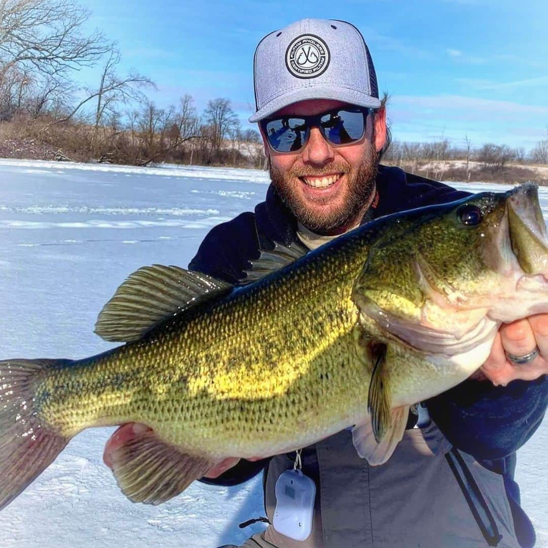 Filthy Anglers™のインスタグラム：「Im guessing our buddy Tyler Bell @tyler_the_fish_whisperer wished he drilled a bigger hole when he saw what was coming up, it just squeezed through! Checkout the second photo. He landed this largemouth up in Wisconsin today. Congrats on the catch Tyler you are Certified Filthy, thanks for the support! www.filthyanglers.com #fishing #teamfilthy #bassfishing #icefishing #outdoors #nature #wisconsin #cobrakai #filthyanglers #angler #monsterbass #bigfish」