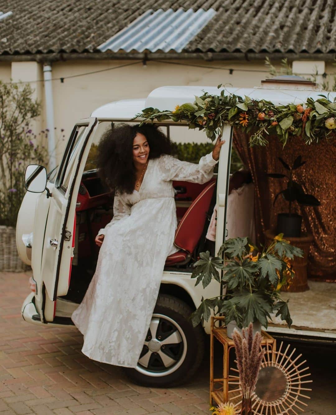 ミナのインスタグラム：「There is an endless amount of themes your wedding can have. I just love summer weddings and to an old soul like me, this 70's style retro wedding shoot with blush and yellow colours, camper van, lampshade arch and our Lucinda dress is quite the perfection! Head to our blog to treat your eyes the rest of the pictures. Link in bio.⁠ ⁠ Are you planning your wedding around a theme? I would love to hear what your theme is and why! Let me know in the comments. 💕⁠ ⁠ Photographer and videographer: @sambennettphoto ⁠ Venue: @strattoncourtbarn ⁠ Florals: @wildsapphireflorist ⁠ Stylist: @thevintagehousethatcould ⁠ Vintage Camper Booth: @vintage_camperbooths ⁠ Cake: @cherrytreecakerie ⁠ Makeup and hair: @tonisearle_mua ⁠ Stationary: @annajaynedesigns ⁠ Jewellery: @fionalucybespoke ⁠ Hair accessories: @aureusflos ⁠ Model: @curlyculzeane ⁠ ⁠」