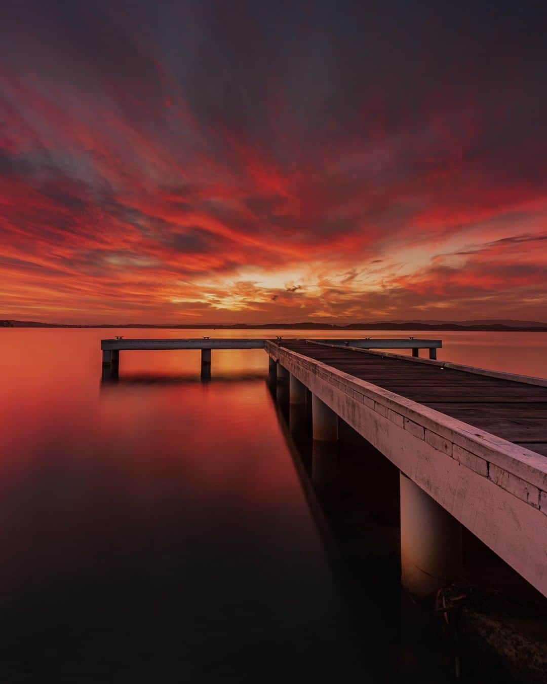 Nikon Australiaさんのインスタグラム写真 - (Nikon AustraliaInstagram)「"Located five minutes from my house, Squids Ink Jetty is one of my favourite spots to shoot around Lake Macquarie. Believe it or not, the Jetty does not actually sit perpendicular. This makes it a fun challenge every time I shoot it in the hope to find a composition that works.  With little potential that evening for the sky to burn, this sunset was an absolute surprise and I was so stoked to capture it! I did not expect it to burn the way it did nor for the duration it lasted. My D750 worked brilliantly in low light, producing a clean and crisp foreground while highlighting the intense colour in the sky." - @leetaylorphoto   Camera: Nikon D750 Lens: AFS NIKKOR 16-35mm F/4G ED VR Setting: f/13  10s  ISO 100  #Nikon #MyNikonLife #NikonAustralia #NikonD750 #SunsetPhotography」1月12日 9時00分 - nikonaustralia