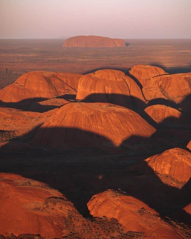 Australiaさんのインスタグラム写真 - (AustraliaInstagram)「Talk about a seriously stunning landscape! 🧡 @kyle_hunter captured this serene sunset over #KataTjuta, with @seeuluru standing tall in the background. To get the same view (and an Insta-worthy shot 🤳) of #UluruKataTjutaNationalPark in @visitcentralaus, try a tour with @ayersrockhelicopters, @professional_helicopters, or @ayersrockscenicflights 🚁. If you’d prefer to stay on the ground, a camel ride with @ulurucameltours at dusk will deliver a hefty dose of @ntaustralia magic. #seeaustralia #NTaustralia #RedCentreNT #SeeUluru #holidayherethisyear」12月21日 4時00分 - australia