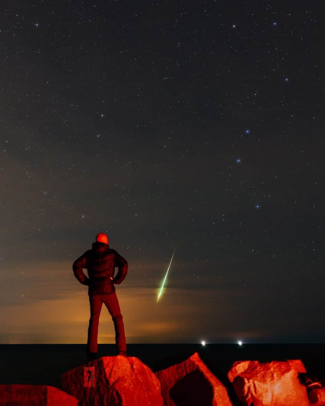 Sigma Corp Of America（シグマ）さんのインスタグラム写真 - (Sigma Corp Of America（シグマ）Instagram)「A colorful fireball of the 2020 Geminid Meteor Shower on December 13/14, seen through the horizon clouds in this lucky scene as SIGMA Ambassador @babaktafreshi poses on a rock. Stars of the Big Dipper and Little Dipper appear in the sky with Polaris (commonly called the North Star), on the top-left.  "Fireball" is a term for dazzling meteors (brighter than planet Venus). While most regular shooting stars are formed by tiny, sand-grain size objects, the much less common fireballs are made by walnut-size or larger objects which may reach the ground as a meteorite.  5-second exposure captured with the SIGMA fp and 20mm F1.4 DG HSM  Art lens.  #SIGMA #sigmaphoto #sigmafp #sigma20mmart #sigma20mmf14art #photography #astrophotography #nightskyphotography #nightsky #meteorshower #meteor #fireball #geminids #geminidsmeteorshower #geminidmeteorshower」12月21日 23時25分 - sigmaphoto