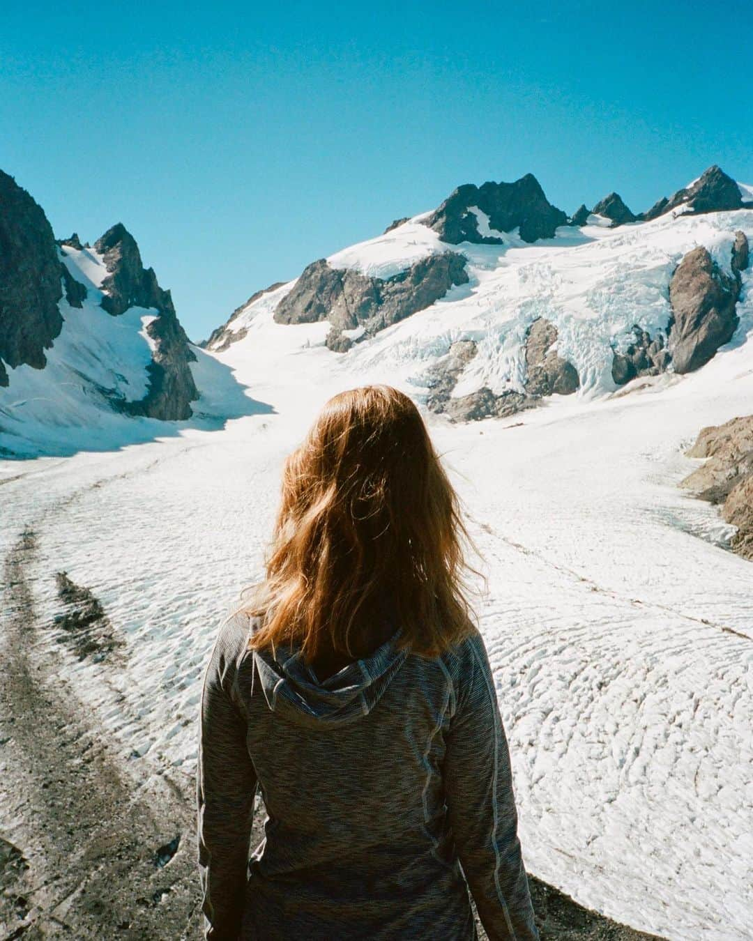 マイラ・ダルブサイオのインスタグラム：「Longest night brings the light. Happy Winter Solstice ✨  @taylorstepien at Blue Glacier, Olympic Peninsula, Washington, 2018  #studiomyla #contaxt2 #kodak #portra800 #gooutside」