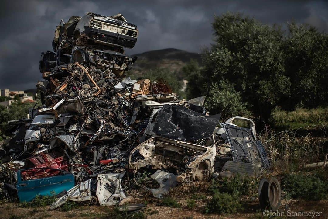 ジョン・スタンメイヤーさんのインスタグラム写真 - (ジョン・スタンメイヤーInstagram)「Following yesterday's internal anthropocene of mysterious beauty in Troy's Garage, to the strange external…an art installation of cars that never made it to a garage. With such care given to balance each relic precisely in place not to topple, within an ancient olive grove in El Ma'ani near Nablus in the West Bank. Who could have imagined 40 centuries ago when Abraham walked this land, the topography today, a towering Jenga of metal as storm clouds approach, and this strange fallacy called time... ⠀⠀⠀⠀⠀⠀⠀ @natgeo #ElMani #nablus #westbank #cars #art #installation #installationart #storm #fromthearchive」12月23日 12時10分 - johnstanmeyer