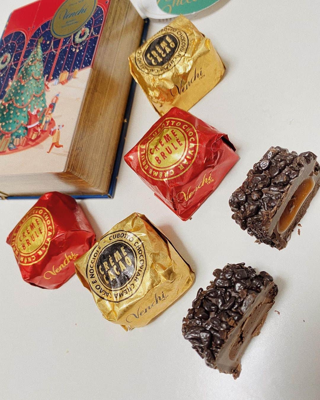 那須愛里さんのインスタグラム写真 - (那須愛里Instagram)「〝𝕄𝕖𝕣𝕣𝕪 ℂ𝕙𝕠𝕔𝕠𝕝𝕒𝕥𝕖 🍫🎅〟﻿  @venchi_jp の﻿ 限定デザインのブック型ケースにはいった こちらをいただきました🎄✨🌙.*·﻿ ﻿ ﻿ CREME CACAO﻿ ジャドゥーヤクリームをミルクチョコレートで包みさらに上には、つぶつぶのダークチョコキャビアを まぶしてあります﻿。 大人なほろ苦さ﻿❤︎ ﻿ ﻿ CREME BRULE﻿ あまから〜い﻿キャラメルブリュレクリームが ダークチョコレートにつつまれていて、程よく甘さを中和させてくれます﻿❤︎ .﻿ .﻿ .﻿ #Venchi #ヴェンキ﻿ #chocolat #chocolate #chocoholic #chocolataddict #chocolatadviser ﻿ #チョコレート好きな人と繋がりたい #チョコレート#チョコレート中毒#チョコレート中毒な私#チョコ中毒 #365日毎日がチョコレート #チョコレート好き #チョコレートに埋もれたい#チョコレートソムリエ #ショコラアドバイザー」12月25日 18時55分 - aaairixoxo