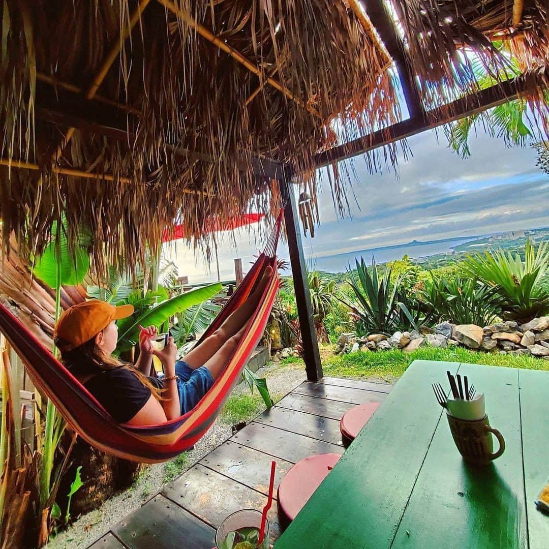 Be.okinawaのインスタグラム：「Nothing better than having a refreshment while resting on a hammock and gazing at the exceptional view of “Tacchu” (Mt. Gusuku in Ie Island)!  📍: Hammock Garden (Annetaichaya)  📷: @meganpicha Thank you very much for your lovely photo!  You can find several cafes with spectacular views in the northern part of Okinawa main island, each with a different ambiance. Find your favorite cafe for delicious food and stunning scenery!  Hold on a little bit longer until the day we can welcome you! Experience the charm of Okinawa at home for now! #okinawaathome #staysafe  Tag your own photos from your past memories in Okinawa with #visitokinawa / #beokinawa to give us permission to repost!  #ハンモック #hammock #本部町 #motobu #모토부 #motobutown #絶景カフェ #美景 #japan #travelgram #instatravel #okinawa #doyoutravel #japan_of_insta #passportready #japantrip #traveldestination #okinawajapan #okinawatrip #沖縄 #沖繩 #오키나와 #旅行 #여행 #打卡 #여행스타그램」