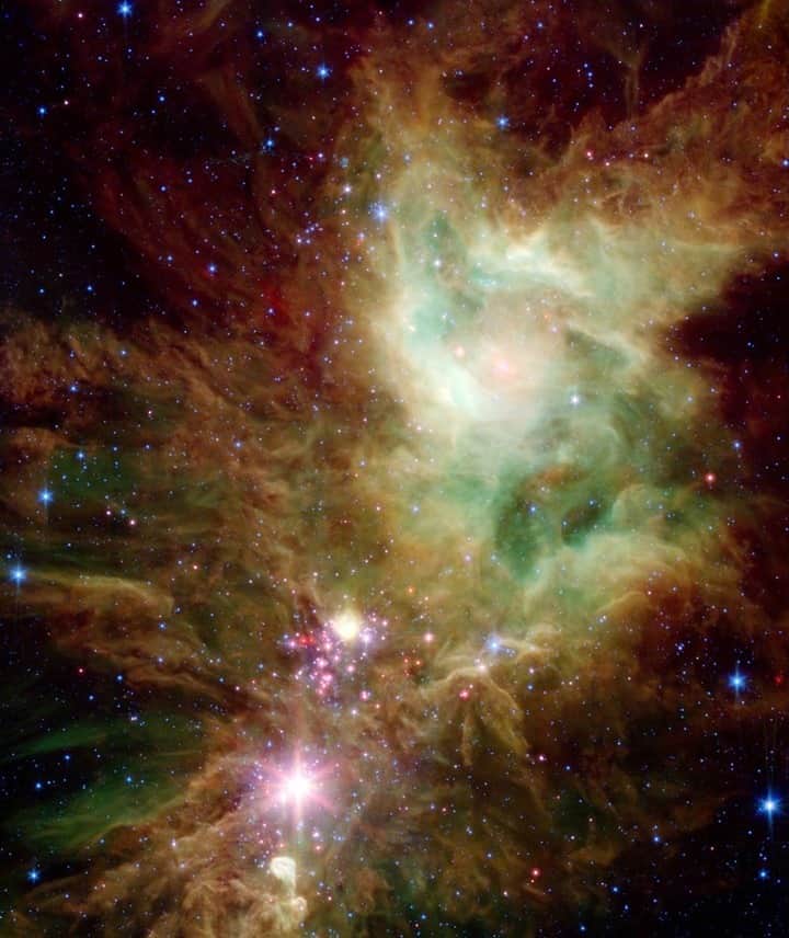 NASAのインスタグラム：「Let it snow! ❄️   Newborn stars, hidden behind thick dust, are revealed in this image of the Christmas Tree Cluster. Infant stars appear as pink and red specks toward the center and appear to have formed in regularly spaced intervals that resemble the pattern of a snowflake.  Just like snowflakes this stellar formation is temporary. Star-forming clouds like this one are dynamic and evolving structures. Since the stars trace the straight line pattern of spokes of a wheel, scientists believe that these are newborn stars. At a mere 100,000 years old, these infant structures have yet to "crawl" away from their location of birth. Over time, the natural drifting motions of each star will break this order, and the snowflake design will be no more.  This image, captured by our Spitzer Space Telescope, immortalizes their fleeting beauty in a cosmic holiday display. ✨🎄   Credit: NASA/JPL-Caltech/P.S. Teixeira (Center for Astrophysics)  #Space #ChristmasTree #Snowflakes #Holidays #Galaxies #Stars」