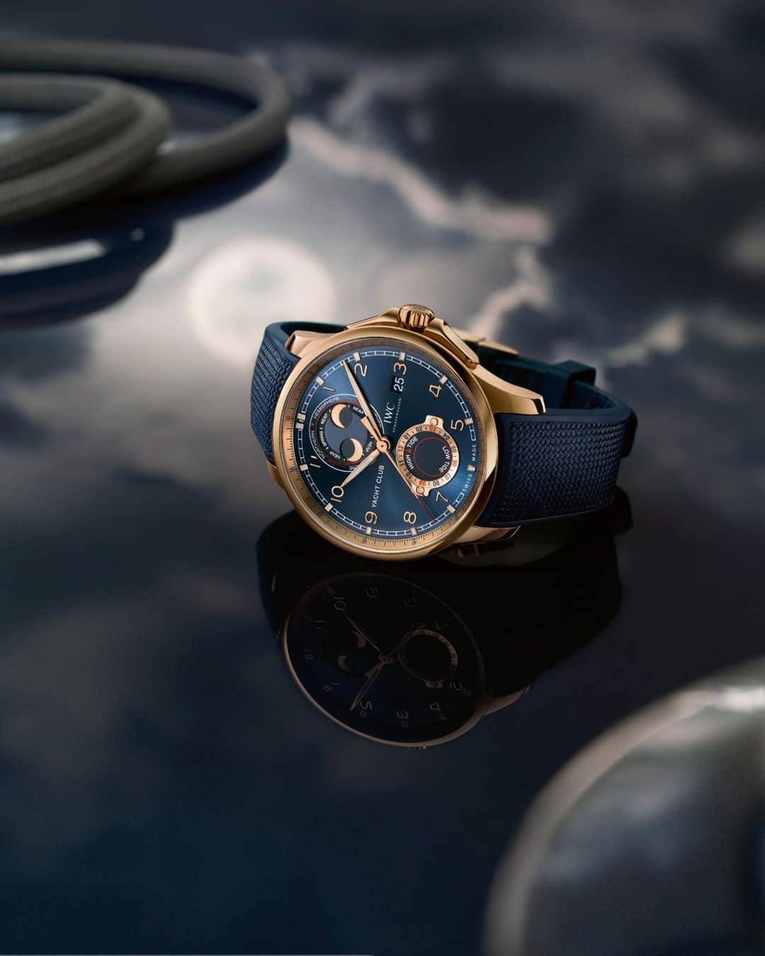 IWCさんのインスタグラム写真 - (IWCInstagram)「A complex interplay of gravitational and centrifugal forces between the earth, the moon and the sun causes the tides. The #IWCPortugieser Yacht Club Moon & Tide (Ref. IW344001) indicates the expected times for the next high and low water on a subdial at "6 o'clock". This is achieved by a reduction wheel train which translates the regular rhythm of the hours into the constantly shifting time sequence of high and low water. The double moon phase display at "12 o'clock" has been enhanced to show spring and neap tides and therefore also informs about the strength of the current tides. Spring tides, which bring particularly high water, occur at full moon and new moon. The 18-carat 5N gold case, blue dial, gold-plated hands and 18-carat gold appliqués underscore the maritime character of this timepiece. The IWC-manufactured 82835 calibre features a Pellaton winding system. Fitted with ceramic components, it boasts a power reserve of 60 hours.」12月28日 23時00分 - iwcwatches
