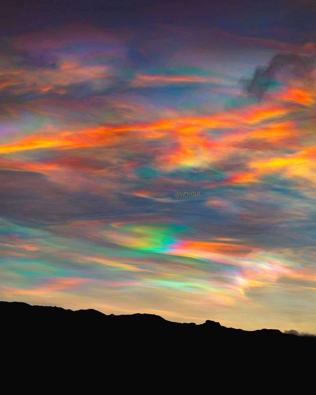 Discover Earthさんのインスタグラム写真 - (Discover EarthInstagram)「Who's ever seen such a beautiful sky? Polar stratospheric clouds (PSCs) are clouds in the winter polar stratosphere at altitudes of 15,000–25,000 m (49,000–82,000 ft). They are best observed during civil twilight, when the Sun is between 1 and 6 degrees below the horizon, as well as in winter and in more northerly latitudes.  "Experienced some of the most incredible polar stratospheric clouds I’ve ever seen in my life few days ago (also called nacreous clouds). The sun was rising so the orange glow blended with those unbelievable rainbow clouds. Polar stratospheric clouds are rare and only form in the Arctic polar region."  #discovericeland🇮🇸 with @h0rdur   . . . . . .  #iceland  #everydayiceland  #igersiceland  #inspiredbyiceland  #icelandair  #wheniniceland  #reykjavik  #mystopover  #ig_iceland  #icelandtravel  #visiticeland  #icelandic  #whyiceland  #exploreiceland  #discovericeland  #aroundiceland  #unlimitediceland  #ísland  #icelandsecret  #loves_iceland  #wowair  #icelandexplored  #alliceland  #islandia  #bestoficeland  #absoluteiceland  #northernlights  #icelandtrip  #waterfall」1月5日 0時00分 - discoverearth
