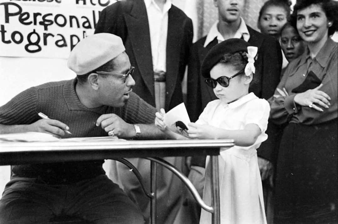 lifeのインスタグラム：「Jazz legend Dizzy Gillespie signs an autograph for a very chic, very tiny fan.   For more of our favorite Gillespie photos, tap the link in bio. (📷Allan Grant, 1948 / LIFE Picture Collection)」