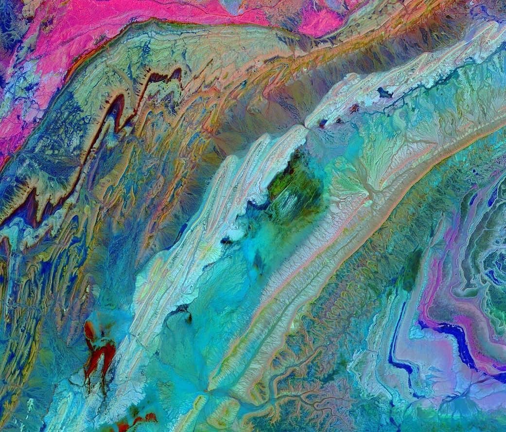 NASAのインスタグラム：「😲GREAT SCOTT!  Let’s take a colorful trip about 440miles (708km) above Earth’s surface via an orbiting satellite, shall we? In this stunning image of southwest Morocco, we see the gorgeous Anti-Atlas Mountains that were formed as a result of the African and Eurasian tectonic plates colliding about 80 million years ago. It was a massive collision that ended up completely destroying the Tethys Ocean.  The photo was taken in infrared light — which is invisible to the naked eye — to highlight the different layers of rock and sediment, giving the tie-dye appearance.  The layers are made up of limestone, sandstone, clay stone, and gypsum. The image was acquired on November 5, 2007, by the ASTER instrument on the Terra satellite. Terra got its name from the Latin word for ‘Earth’ and was the first satellite to form the Earth Observing System (EOS) when it launched in 1999.  *We apologize in advance if your ears popped on the way there! 😏  Credit: NASA/METI/AIST/Japan Space Systems, and U.S./Japan ASTER Science Team  #NASA #Infrared #ChasingMarrakech #Morocco #TBT #Views #Earth #Terra #RockOn」