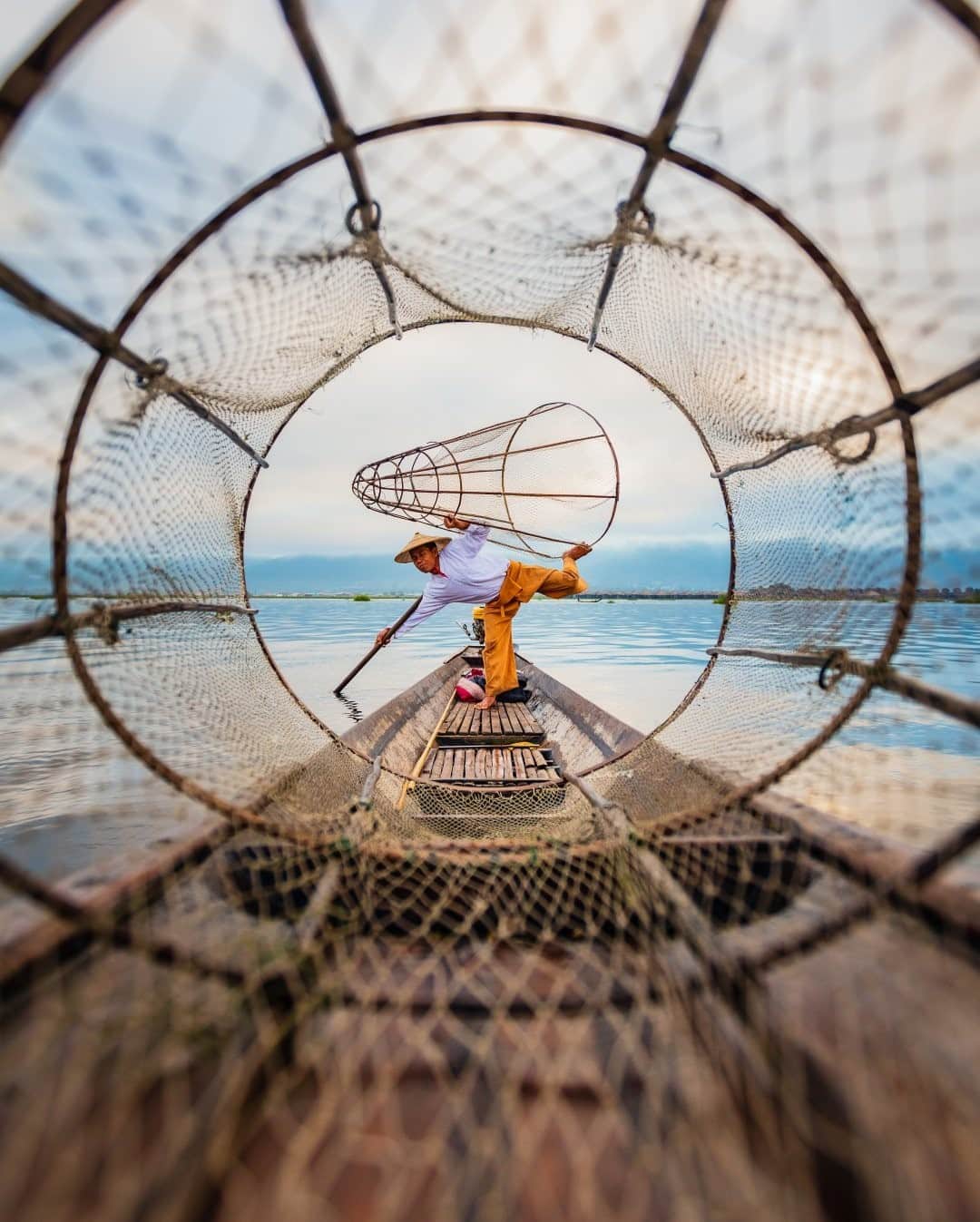 National Geographic Travelさんのインスタグラム写真 - (National Geographic TravelInstagram)「Photo by @tobyharriman / Though this traditional fishing method in Inle Lake, Myanmar, is no longer used, you can still see the performers reenacting it for tips. Today, the real fishermen have ditched the large, conical nets for a different technique: They set up nets underwater and then row to a different area while scaring the fish back into the nets. The performances are a win-win-win: Tourists get a glimpse into Inle Lake’s past, the performers have jobs (mostly working for tips), and the real fishermen benefit because the performers keep away the noisy tourist motorboats. One thing the traditional and the modern methods have in common is that the fishermen row with one leg!  Follow @tobyharriman for more. #inlelake #myanmar #burma」2月5日 0時38分 - natgeotravel