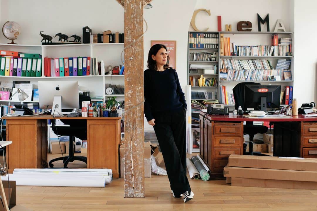 ルモンドのインスタグラム：「Quand on lui a proposé l’idée de ce reportage, Alexandra Henochsberg, directrice de la société de distribution Ad Vitam, n’a pas tenu dix secondes avant de partir dans un long fou rire. Qu’attendre, par temps de Covid-19 et d’arrêt total d’une industrie du cinéma sonnée sur pied, de la rencontre d’une distributrice et d’un critique ?⁣ Ad Vitam, créé en 1998, est un fleuron du cinéma indépendant. Pascale Ferran, Jia Zhang-ke, Marco Bellocchio, Philippe Garrel, Gustave Kervern et Benoît Delépine sont des habitués de la maison.⁣ Alexandra Henochsberg nous explique que la situation est compliquée : « J’ai à peu près vingt-cinq films sur les bras, entre ceux dont la carrière a été interrompue par le confinement, comme Drunk, de Thomas Vinterberg, ou ADN, de Maïwenn, ceux qui portent le label Cannes 2020 et qu’il faudrait quand même sortir avant Cannes 2021, et ceux qui viennent d’être tournés. » Ad Vitam a ainsi une douzaine de films à présenter au Festival.⁣ « Tous mes collègues sont dans la même situation. Nous lisons des scénarios, nous voyons des films, mais nous ne pouvons plus en prendre, ça n’aurait aucun sens. Il va y avoir un problème grave lors de la réouverture des salles. On va se retrouver avec cent cinquante films qui attendent leur sortie, dont les grosses machines françaises et américaines qui tablent sur une vraie reprise à l’automne. Et comme personne ne veut entendre parler de régulation, ça va être la guerre. »⁣ -⁣ La distributrice de films Alexandra Henochsberg, le 26 janvier 2021, dans les locaux de la société Ad Vitam à Paris. Photo : Mathieu Zazzo (@matzazzo) #PourLeMonde⁣ -⁣ #cinema #culture」