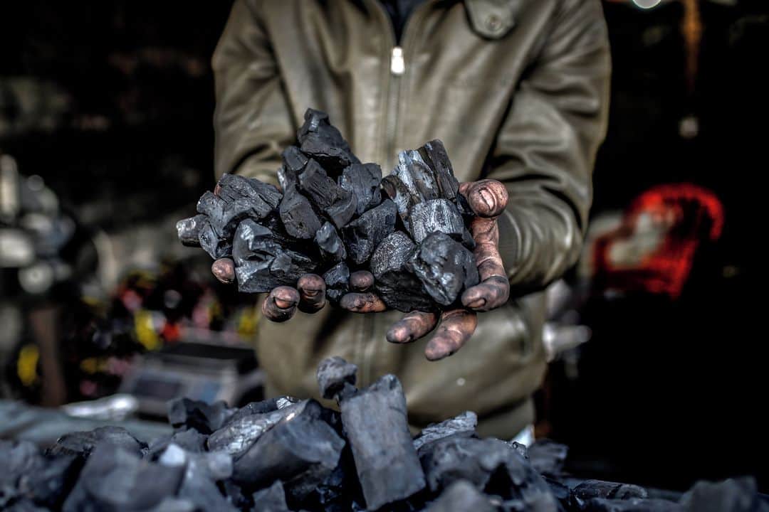 AFP通信さんのインスタグラム写真 - (AFP通信Instagram)「AFP Photo 📷 @mohmdbaba - Al-Hattab charcoal production facility, east of Gaza City -⁣ .⁣ Eight men work throughout the year, especially during winter and holiday periods when coal is in high demand.⁣ ⁣ While workers cut down various types of trees, the citrus tree is very useful and the most expensive but the Al-Hattab workers don't focus on only one type of wood and work also with Elkinia and Olivewood. After harvesting the trees, workers shape the wood into a pyramid that is buried beneath the sand.⁣ ⁣ The pyramid is set on fire, and it burns from the inside for several days. During this period, workers must control the burning by regularly moistening the pyramid with water.⁣ ⁣ When the fire has subsided, the sand is cleared, leaving the burned wood exposed for 6 days. The workers are then able to harvest and clean the raw charcoal.⁣ ⁣ The facility produces 80 to 90 tons of charcoal annually. At the end of the production process, customers can purchase bags of charcoal directly from the factory. One kilogram is sold for US$1.50 on-site and US$2.50 in the markets.」2月6日 18時20分 - afpphoto
