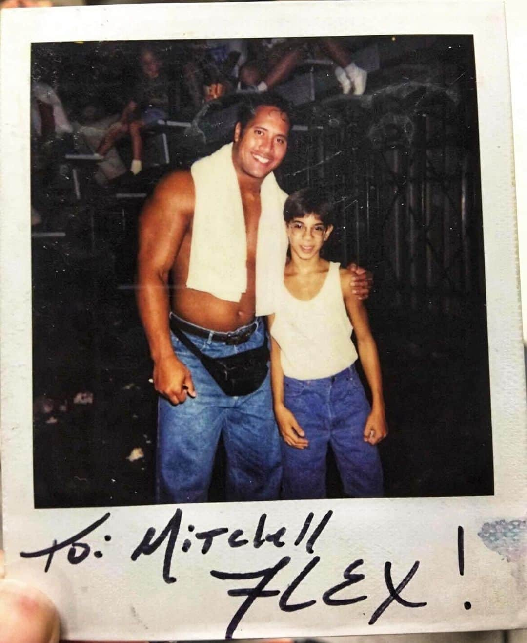 ドウェイン・ジョンソンさんのインスタグラム写真 - (ドウェイン・ジョンソンInstagram)「Just...wow 🤦🏽‍♂️ TBT to me and a young fan after my wrestling match at the flea market in Memphis.   My ring name was “Flex Kavana” (hey I thought it was a cool name at the time🤣) and I was making a GUARANTEED $40 bucks per match.   I was broke as hell, passionate and gave it all I got - having NOOO IDEA the long, windy, unpredictable road that lay ahead.   Sounds crazy but looking back at this time - these nights of wrestling at flea markets, fairs, high school gyms, used car dealerships etc...this is where I learned the value of always taking care of the audience and sending them home happy.    And for $5 bucks you can go home happy too just like Mitchell here and take a polaroid with your favorite wrestler..  wearing jorts and a cool ass leather fanny pack hanging low.  F*ck 🤦🏽‍♂️ Sorry Mitchell.. I own you one 👊🏾🥃」1月15日 4時41分 - therock