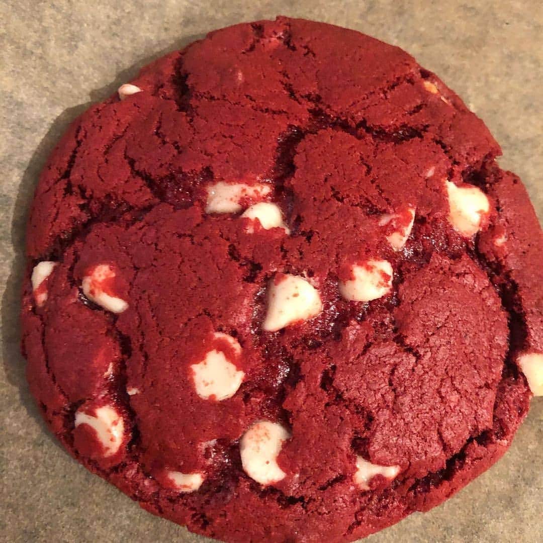 Cesar Gonzalez Cocineroのインスタグラム：「GALLETAS RED VELVET CON CHISPAS 😍 De esta receta saldrán unas 24 galletas. Me muestran como les queda mencionandome en sus historias 👇.   Ingredientes:  360 g de Harina todo uso 1¼ cdta de Bicarbonato ½ cdta de Sal 238 gde Mantequilla sin sal 280 g de Azúcar morena 60 g de Azúcar blanca 1 cda de Colorante líquido Rojo comestible 1 Huevo grande más 1 Yema 2 cdtas de Extracto de Vainilla 1 cda de Yogur griego (puedes sustituir por crema agria) 1 taza de chispas de Chocolate Blanco (también pueden ser de Chocolate Oscuro) Un frasco de 500 g de Nutella, refrigerado Sal marina gruesa para rociar (opcional)  Preparación: -Combina la Harina, el Bicarbonato de sodio y la Sal en un bowl. Reserva  -Mezcla la Mantequilla derretida, los dos tipos de Azúcar y el Colorante rojo, hasta que estén completamente mezclados.  -Bate el Huevo, la Yema, la Vainilla y el Yogur o Crema agria hasta que estén combinados.  -Agrega los ingredientes secos lentamente y bate a baja velocidad hasta que estén bien integrados. Agrega los Chips de Chocolate y mezcla ligeramente -Deja reposar la masa resultante durante 2 horas en el refrigerador.  -Mientras, coloca 1 o 2 cucharadas de Nutella en una bandeja con papel encerado.   -Lleva a la nevera hasta que hayan transcurrido las 2 horas de reposo de la masa de Galletas.  -Transcurrido este tiempo, toma un poco de masa de Galleta y envuelve las cucharadas de Nutellas que deben estar firmes en este punto. Luego aplana la bola de masa con la mano y dales forma de Galleta. Asegúrate de que la Nutella no se escape de la masa, en tal caso, agrega más masa si es necesario.  -Coloca las Galletas sobre la bandeja a 5 centímetros de distancia entre ellas y aplana ligeramente y suavemente con la mano.  -Hornea a 180°C durante 9-11 minutos o hasta que los bordes de las galletas empiecen a dorarse.  -Deja enfriar las galletas por lo menos 2 minutos.  -Espolvorea con un poco de Sal marina (opcional).  ¡Disfruta! 😁」