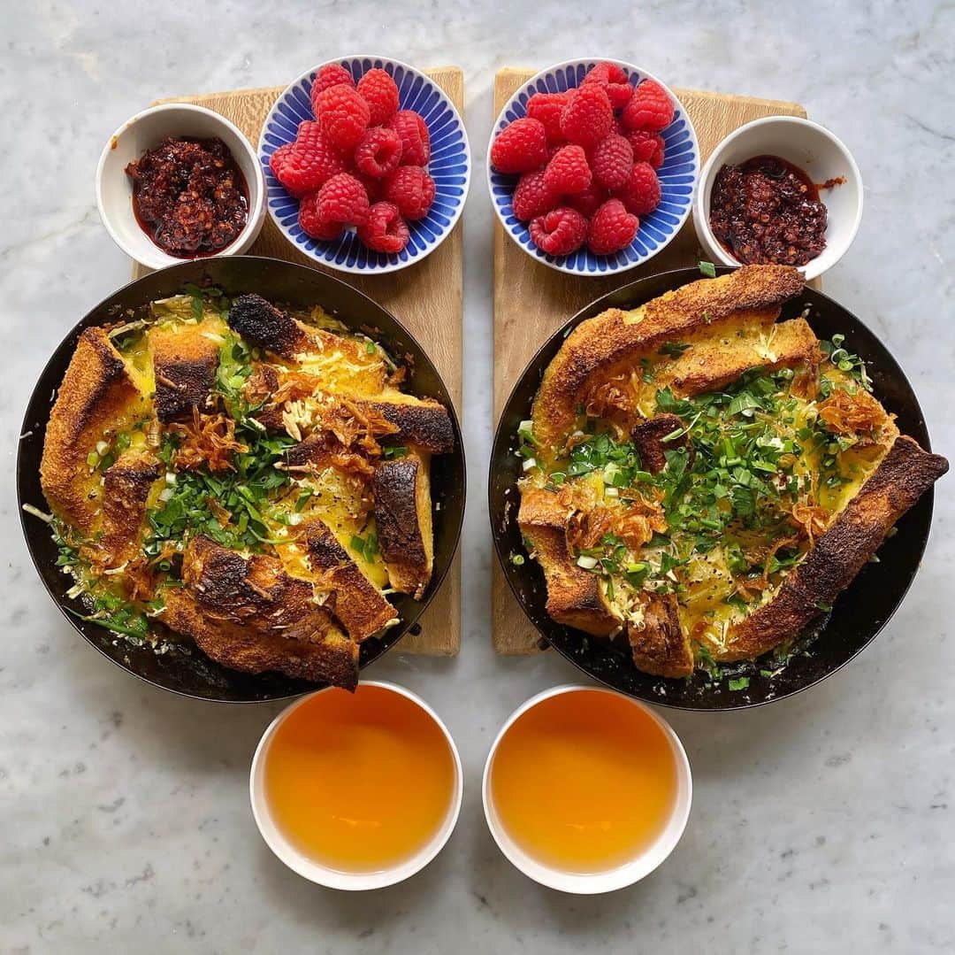 Symmetry Breakfastのインスタグラム：「Savoury Bread Pudding 🍞 like a baked French toast using the last of that GIANT loaf 大列巴 from Harbin. Here I went heavy with the black pepper and used some @violife_foods vegan cheese and almond milk instead (although I did use eggs so not vegan) finished with onion oil, lao gan ma chilli crisp with lots of chopped parsley and spring onion. l love the soufflé texture inside, the bits that didn’t soak up the liquid and the crunch and burnt bits. Simple but full of texture and complexity ❤️ #symmetrybreakfast #dairyfree」