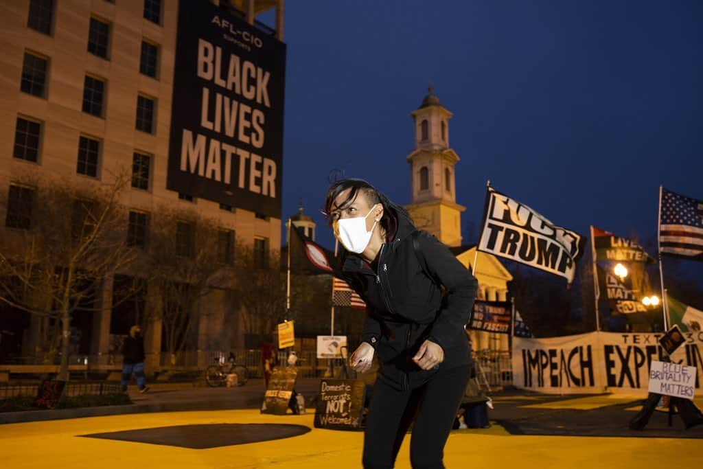 National Geographic Creativeさんのインスタグラム写真 - (National Geographic CreativeInstagram)「Photo by @nina_berman / Two blocks from the White House, Starlette Thomas dances at Black Lives Matter Plaza, which was open to visitors while the surrounding area in Washington, D.C., was fenced off—part of unprecedented security measures for the presidential inauguration.」1月17日 22時13分 - natgeointhefield