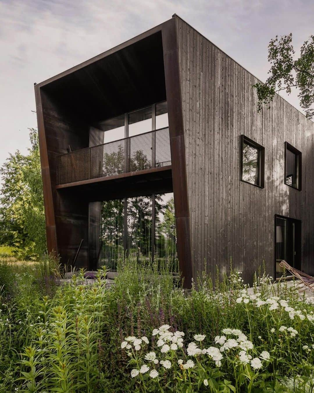 Architecture - Housesのインスタグラム：「⁣ 𝗔𝗿𝗰𝗵𝗶𝘁𝗲𝗰𝘁𝘀’ 𝗛𝗼𝘂𝘀𝗲 🖤⁣ The structure of this house was built offsite as a prefab. Timber is a versatile, sustainable and resilient building material and it allowed to create the tilting shape of the house.The grey-stained Baltic timber cladding has a silver patina which is complemented by the rusted metal entranceway and window surrounds.⁣ What do you think about this #architecture material? Do you like how it works in this project?⁣ Leave your comment...we read you!🧐⁣ _____⁣⁣⁣⁣⁣⁣⁣⁣⁣⁣⁣⁣⁣⁣⁣⁣⁣⁣⁣⁣⁣⁣⁣⁣⁣⁣⁣⁣⁣⁣⁣⁣⁣⁣⁣ 📐@openad_lv 📍Bierini, Riga, Latvia⁣ #archidesignhome⁣ _____⁣⁣⁣⁣⁣⁣⁣⁣⁣⁣⁣⁣⁣⁣⁣⁣⁣⁣⁣⁣⁣⁣⁣⁣⁣⁣⁣⁣⁣⁣⁣⁣⁣⁣⁣ #architect #arquitectura #luxury #architettura #interiordesign #archilovers #home #house ‎#amazing #architecturephotography #amazingarchitecture⁣⁣ #realestate #photooftheday #construction #archilovers #home #house ‎#amazing #picoftheday #archigram #ModernArchitect #building」