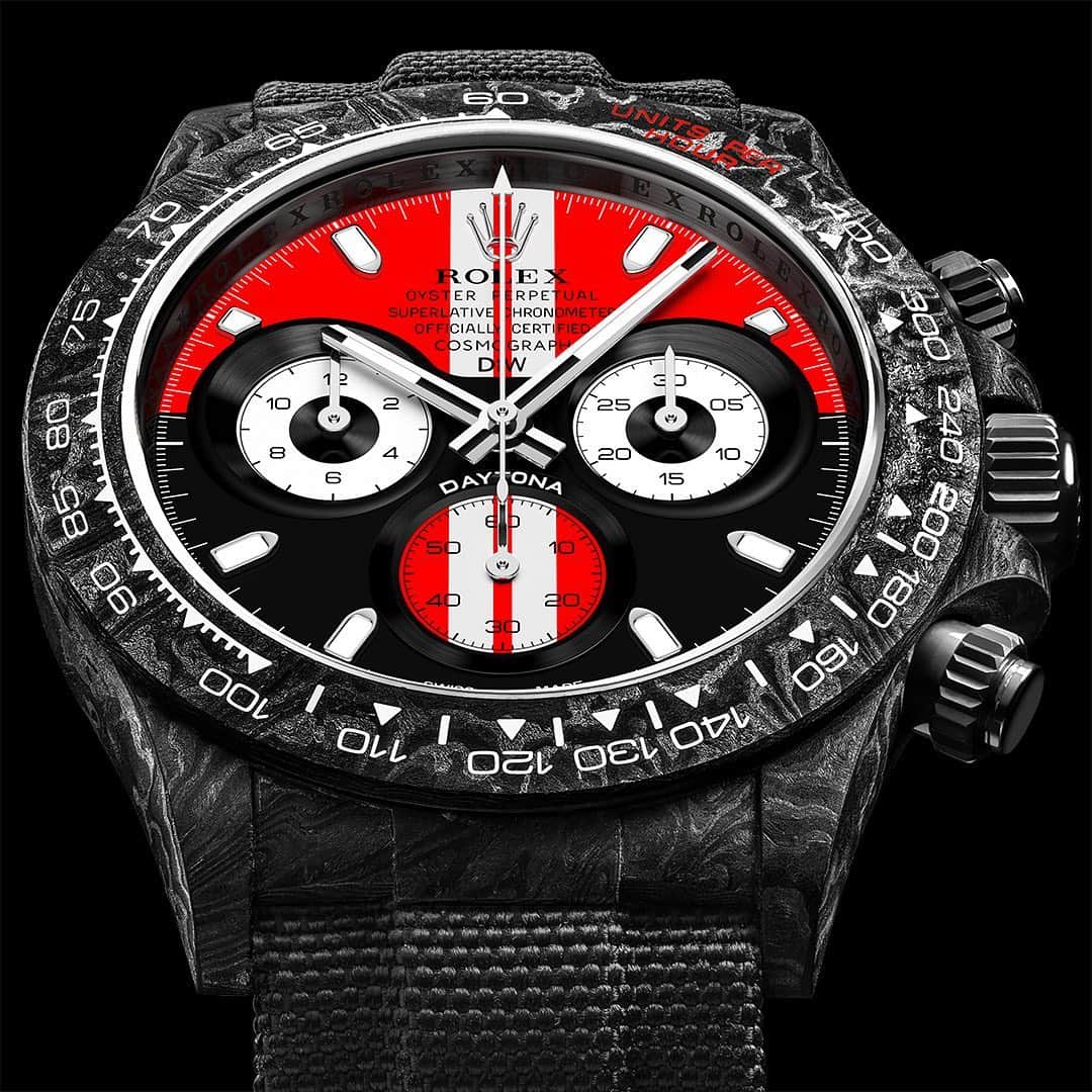 WATCHMANIAのインスタグラム：「The glorious Daytona GT Red by @diw_official is out. The highlight of the Grand Tourer series and limited only to 5 pieces. Carbon fiber suits perfectly. Can you guess which car this piece was inspired on?  #DiW #DiW_watch #DiWcustomwatches #customwatch #diwwatches #diwwatch #DesignaIndividualwatches #RolexDiW #customrolex #watchcollector #rolexwatch #rolexdaytona」