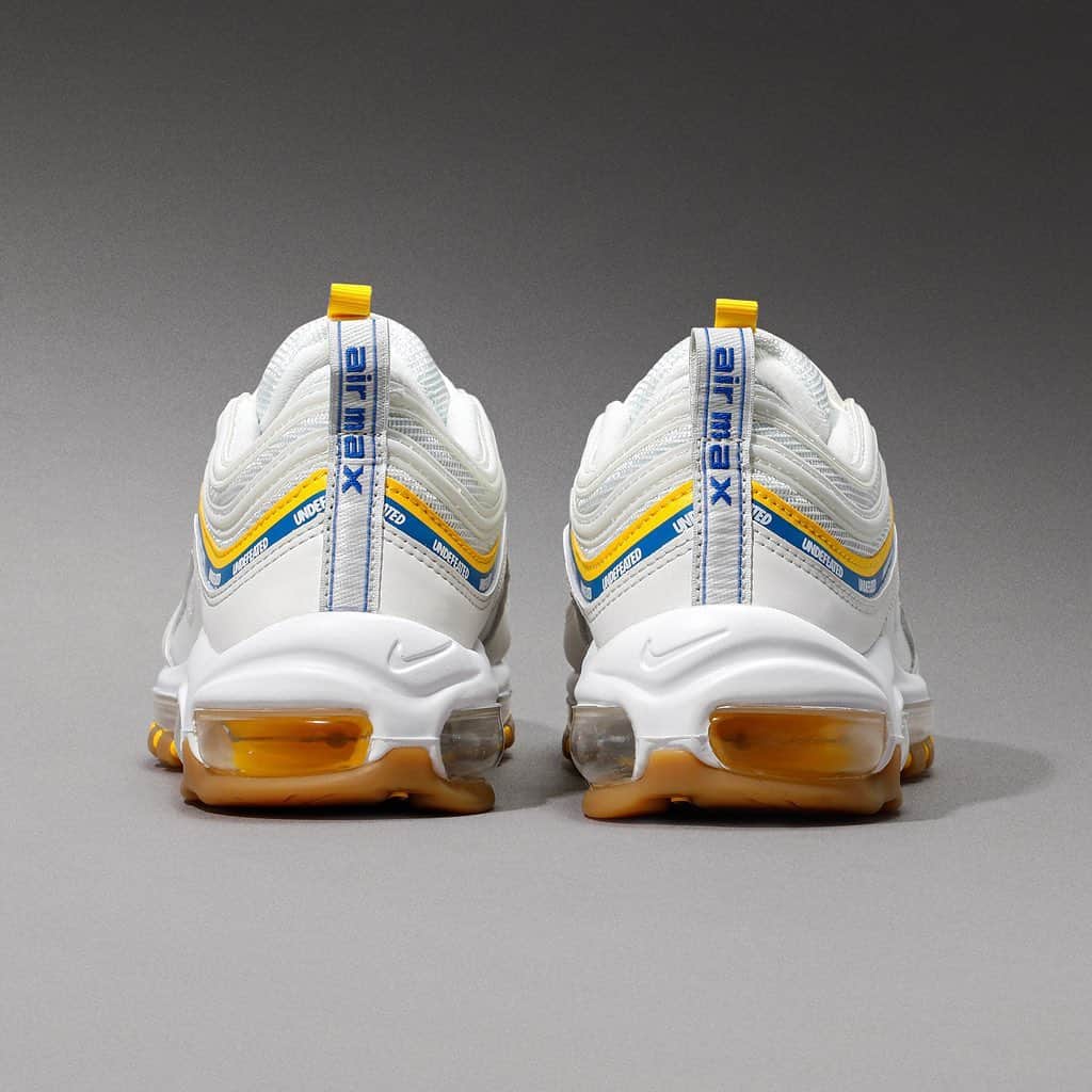 Flight Clubさんのインスタグラム写真 - (Flight ClubInstagram)「Los Angeles based boutique Undefeated dials back into the Air Max 97 with a ‘UCLA Bruins’ twist, giving a nod to the university with Aero Blue and Midwest Gold accents, while the Undefeated branding wraps around the design in the shoe’s signature overlays. The white base is subtly contrasted by a gum outsole and supported by a full-length Max Air Unit.」1月19日 0時04分 - flightclub