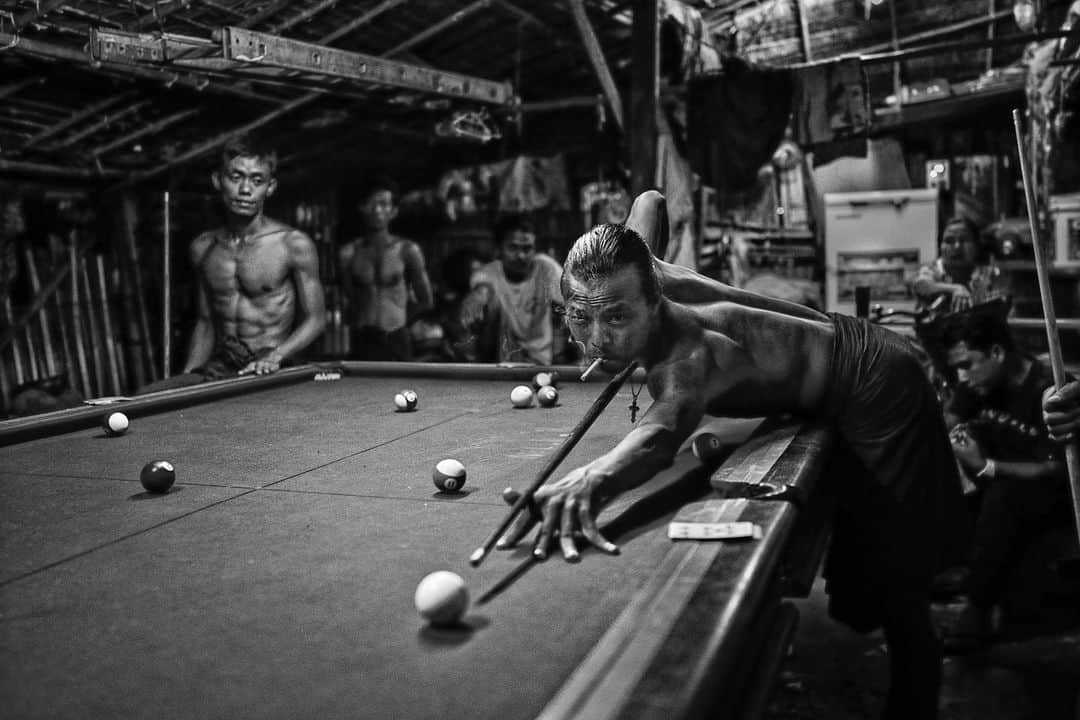 thephotosocietyさんのインスタグラム写真 - (thephotosocietyInstagram)「Photo by @rubensalgadoescudero // Men play pool in a small pool hall in Yangon, Myanmar. Myanmar is going through turbulent times with violence spreading between different religious groups throughout various regions of the country. For now, Yangon-its former capital- still has a majority of acceptance of people from all beliefs. Wether it be Hindu, Christian, Buddhist or Muslim, this pool-hall on the side of a small shack depicts the sense of diverse community in the streets of Yangon and its tolerance for one another. The way the Burmese play this version of pool which they call 'Pe Chaé', is quite different to the west. The game here is a combination of playing cards with American pool, where each player has to put in the balls according to the numbers on their deck of cards. Pe Chaé plays an important role in social interactions between Burmese men, and although most games are played for money, the atmosphere here is of friendship and respect.  Follow me on @rubensalgadoescudero to see the world through my lens…  #pool #bw #myanmar #yangon #burma #billar #snooker」1月19日 7時51分 - thephotosociety
