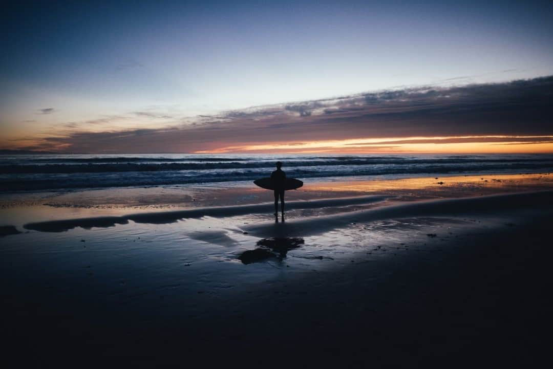 National Geographic Travelさんのインスタグラム写真 - (National Geographic TravelInstagram)「Photo by @steven_gnam / A surfer pauses to watch the sunset after a session along the Santa Barbara coastline. #surf #California」1月19日 8時35分 - natgeotravel