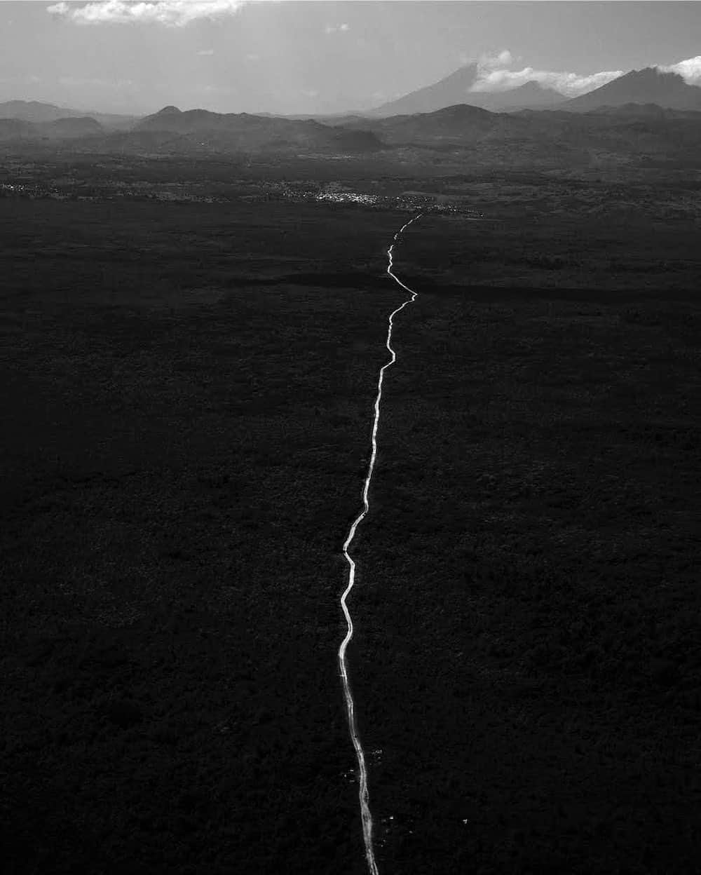 thephotosocietyさんのインスタグラム写真 - (thephotosocietyInstagram)「Photo by Michael Christopher Brown @michaelchristopherbrown. Aerial of a jungle road leaving Virunga National Park, located in eastern Democratic Republic of the Congo. Among the most protected areas of Africa, Virunga, Africa’s first national park, was designated  a UNESCO World Heritage site in 1979. Home to active volcanoes and hundreds of endemic species including Eastern Gorilla and Golden Monkey, while living in Goma I spent much time traveling through the lush, remote 3000 square mile area full of grandeur. Virunga made headlines recently when 12 of its park rangers were killed while protecting the safety of people and animals in the park, ever at the mercy of poachers, militias and others looking to take advantage of park resources.」1月19日 10時40分 - thephotosociety